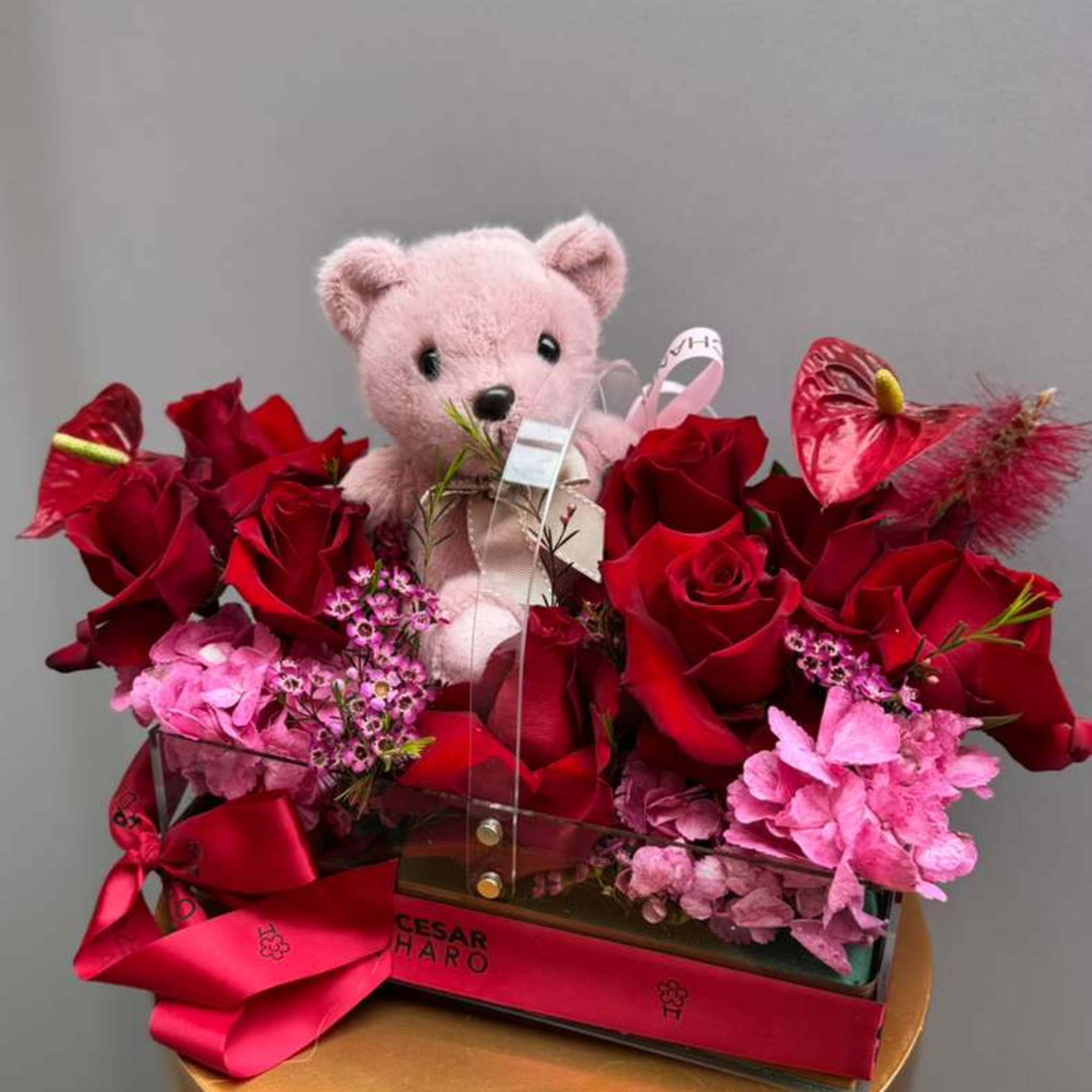 A clear rectangular basket filled with a romantic blend of pink and