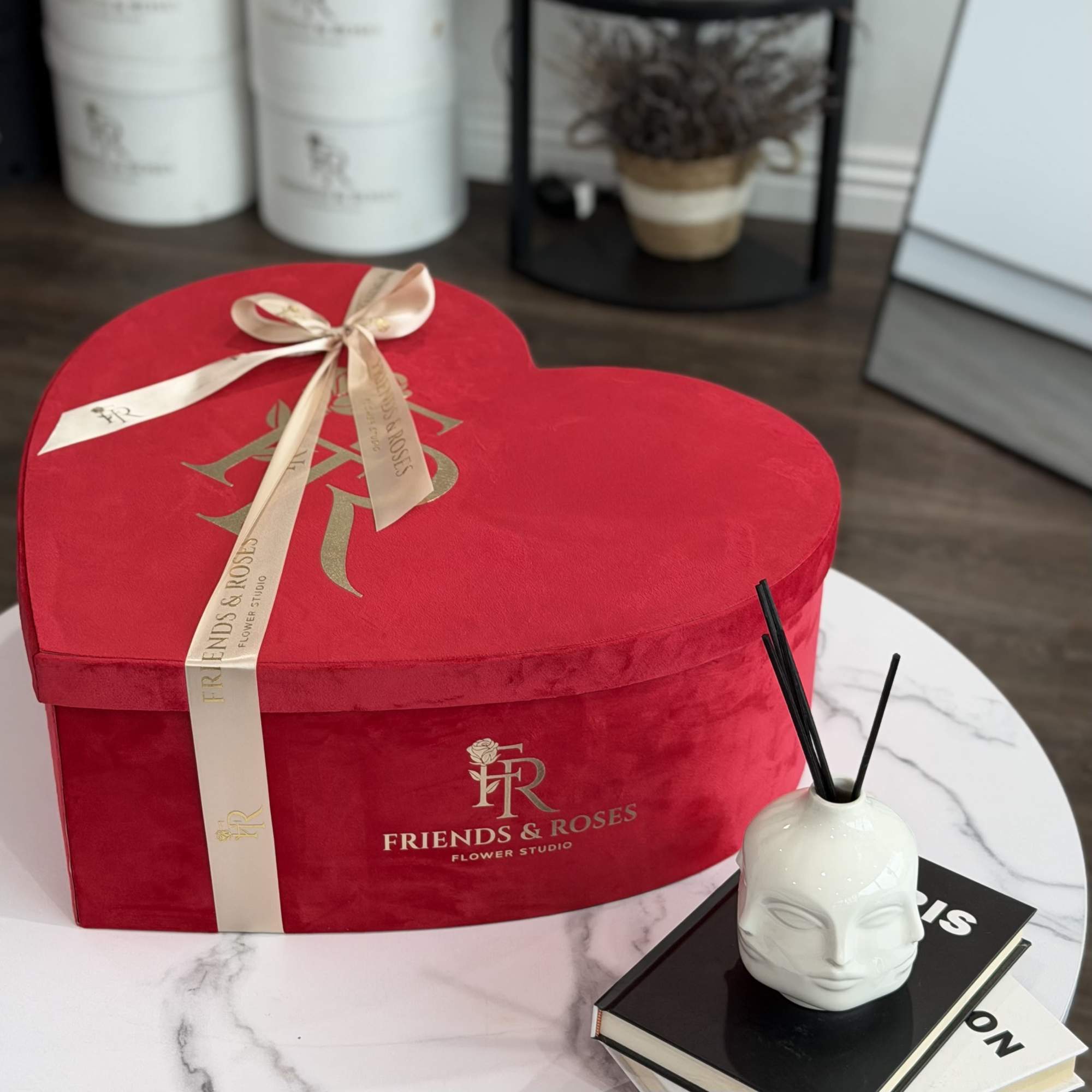 A large heart of velvety red and delicate ivory roses, designed to