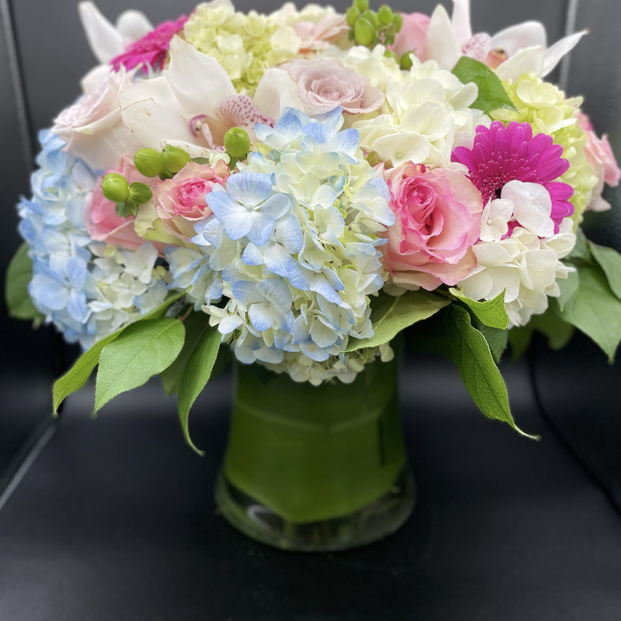 This cylindrical vase of flowers is kind of like a time capsule