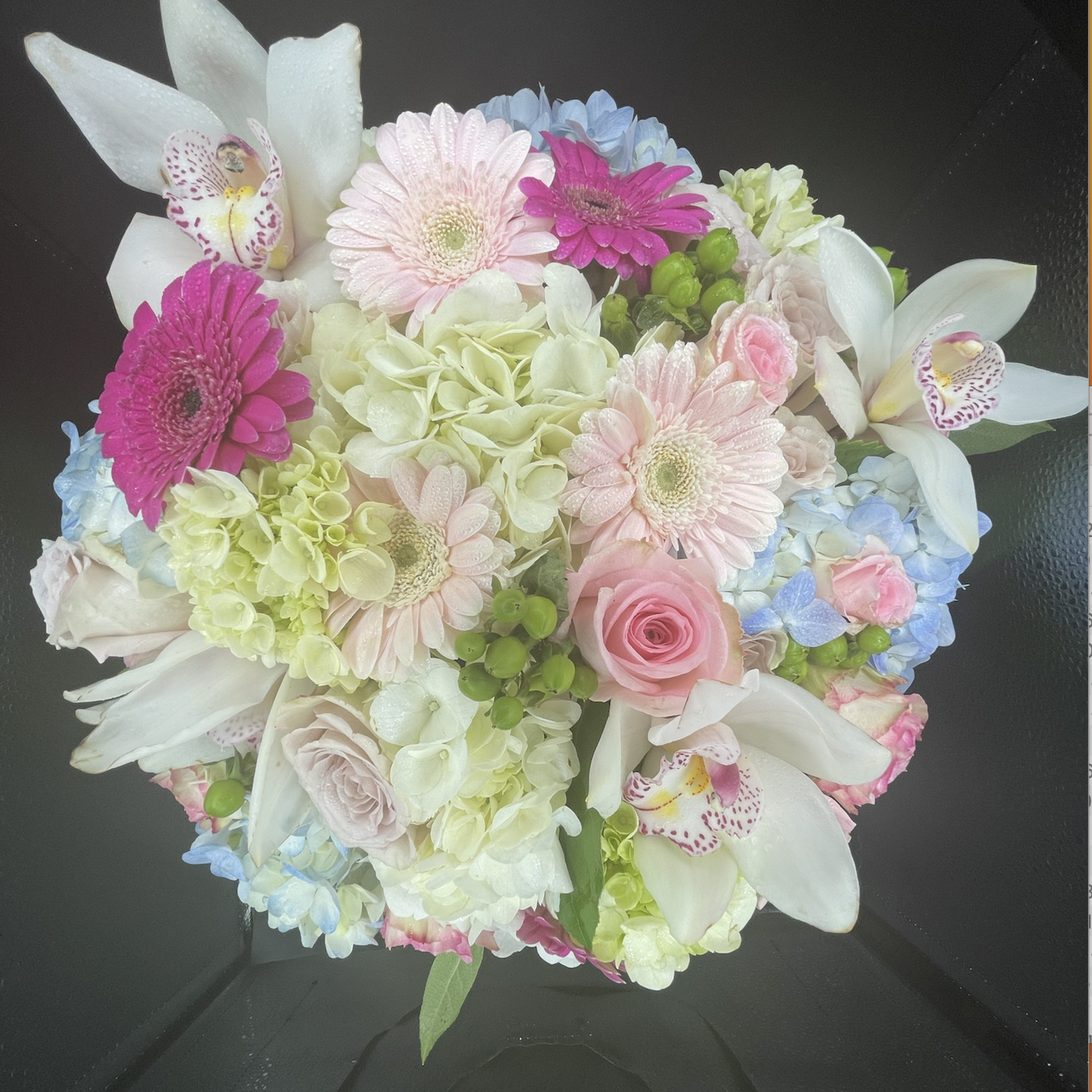 This cylindrical vase of flowers is kind of like a time capsule