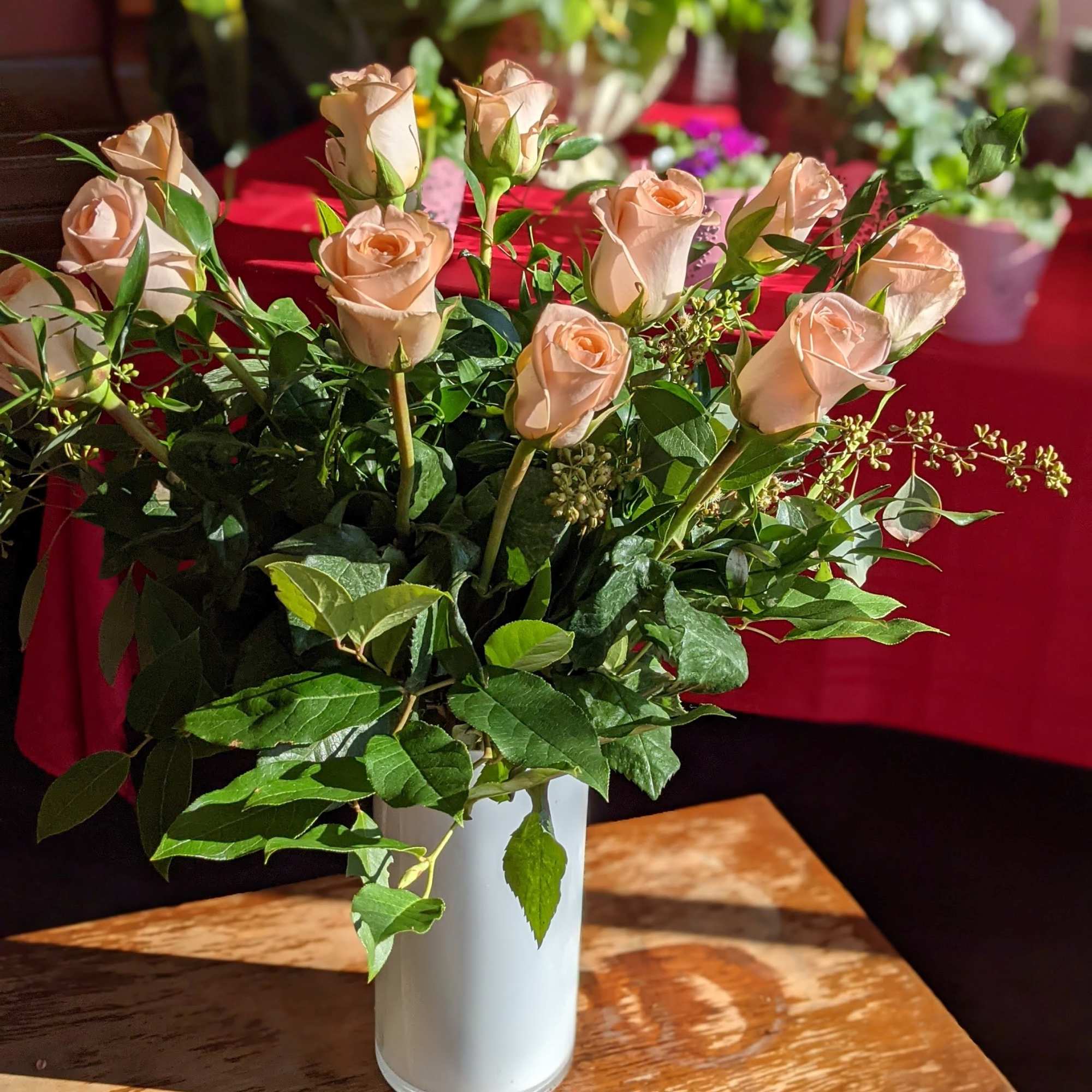 A timeless classic, send a dozen roses in a vase with complementing
