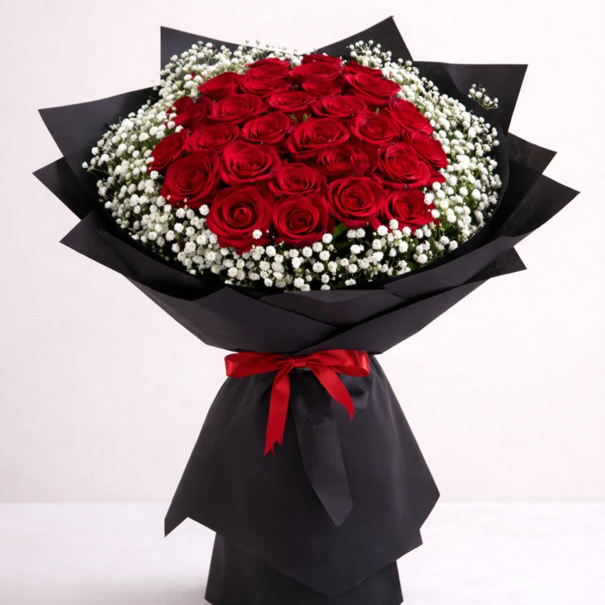Product Information
Our bouquet showcases 25 luxurious long-stemmed red roses, hand-tied with fresh