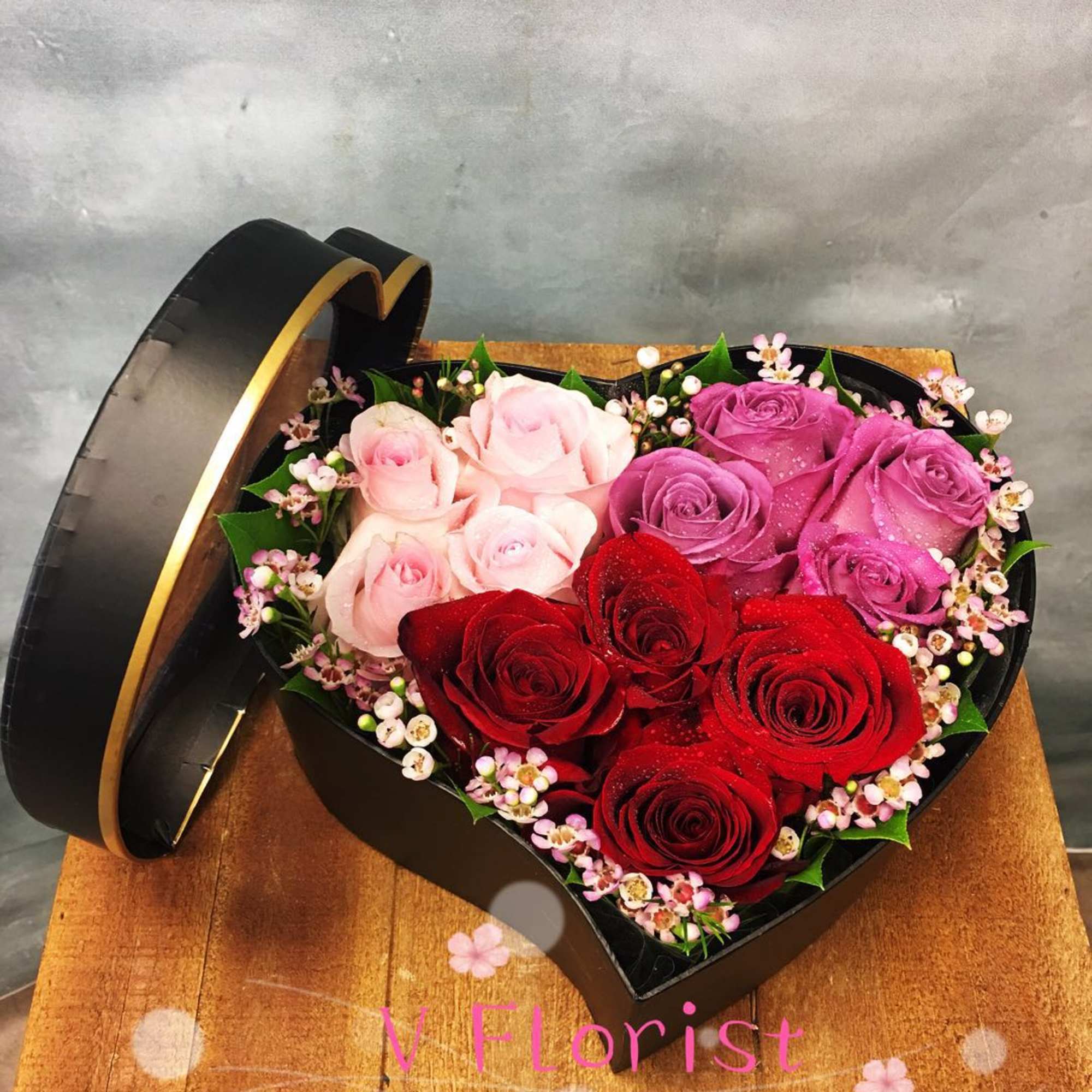 Assorted colors of roses in a heart-shaped box in 3 sizes. Standard: