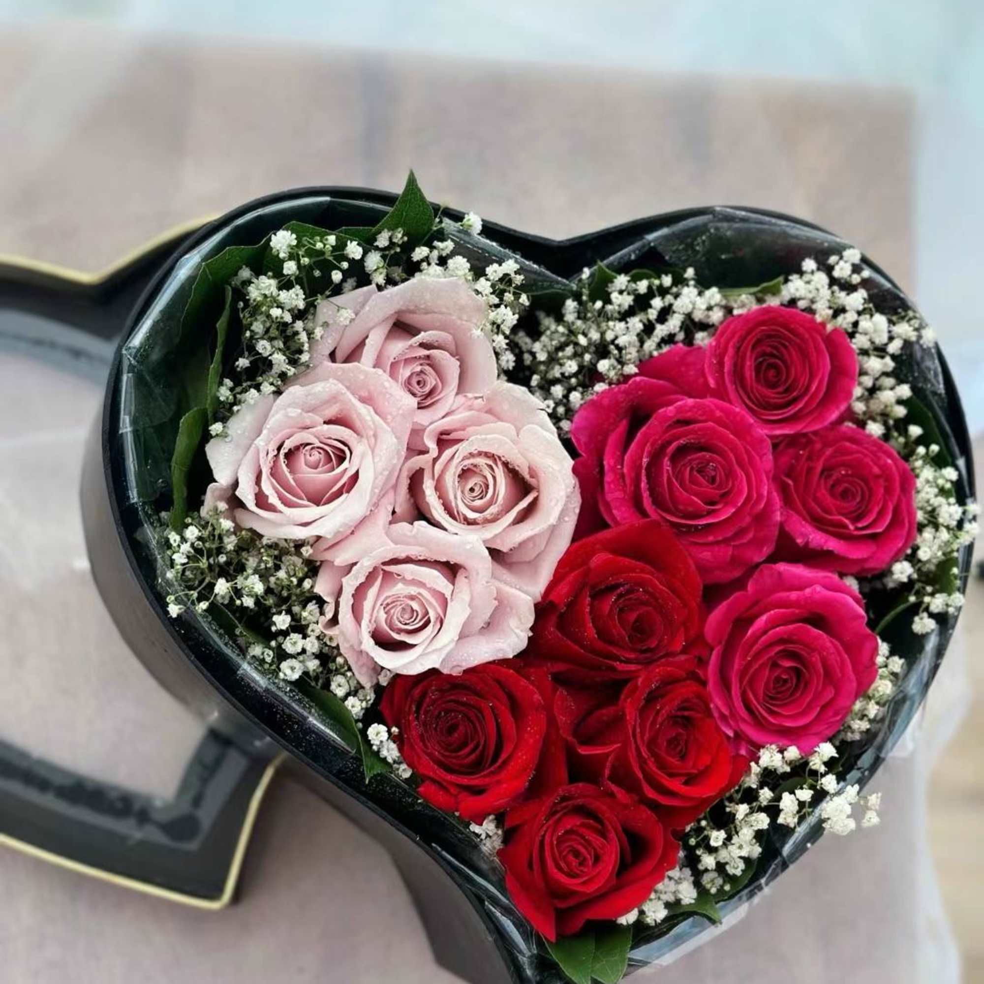 Assorted colors of roses in a heart-shaped box in 3 sizes. Standard: