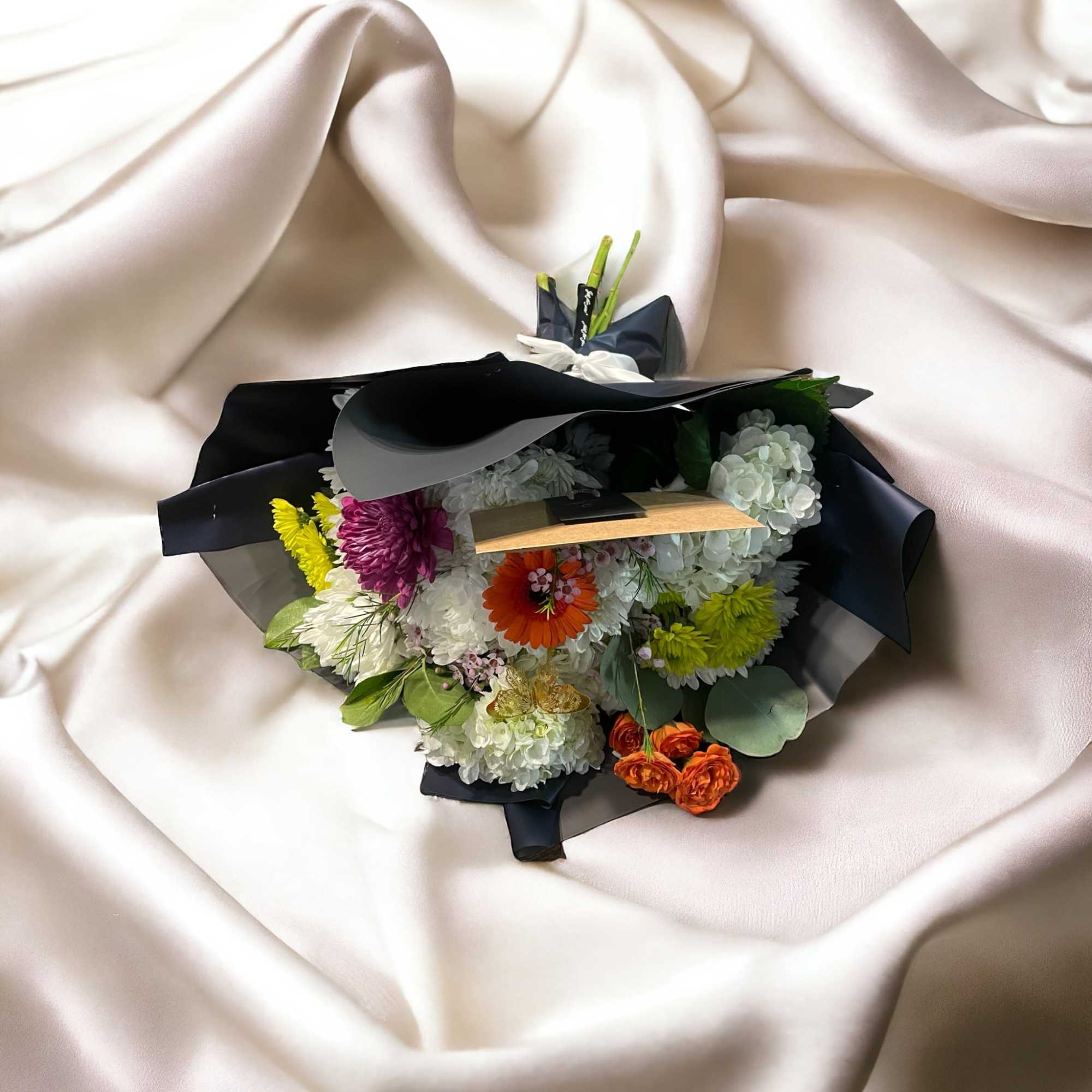 Featuring a wide, wondrous assortment of blooms in one bouquet, this white