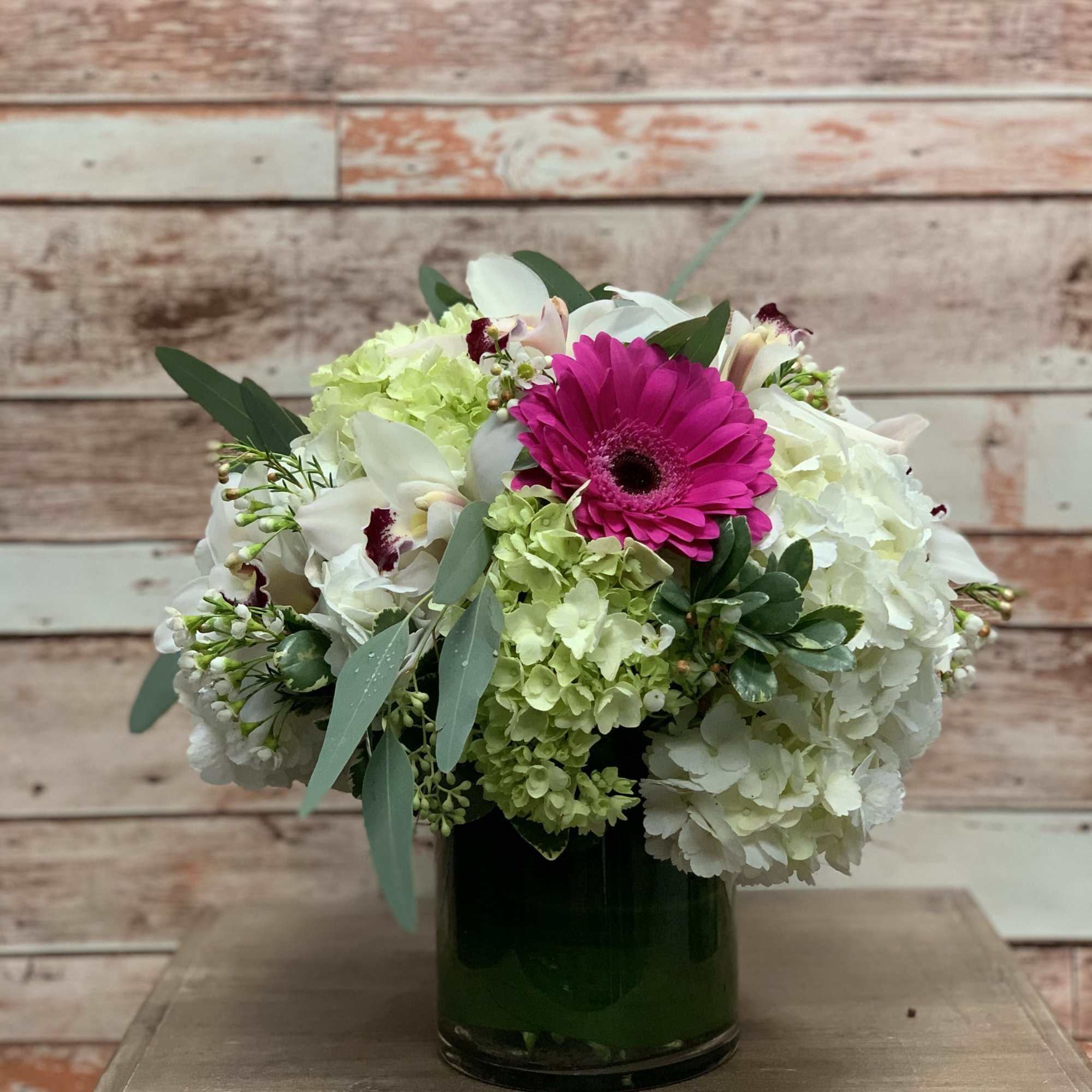 A bright white arrangement with a pop of hot pink! Bright and