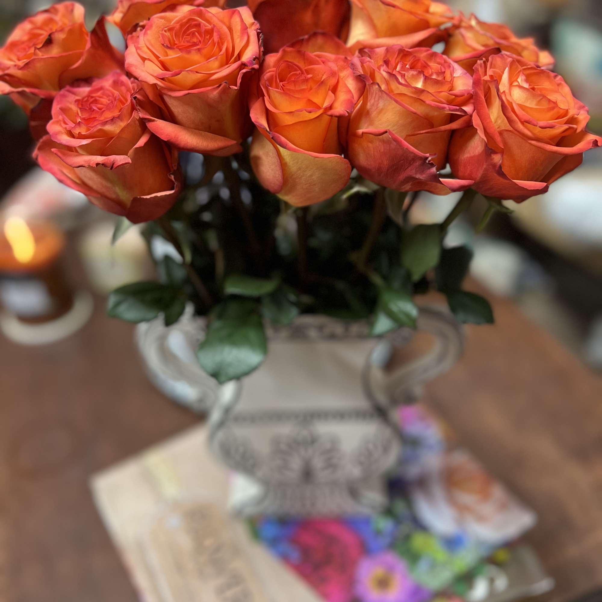 12 Tangerine Roses placed in a Trendy Abstract Ceramic Vase