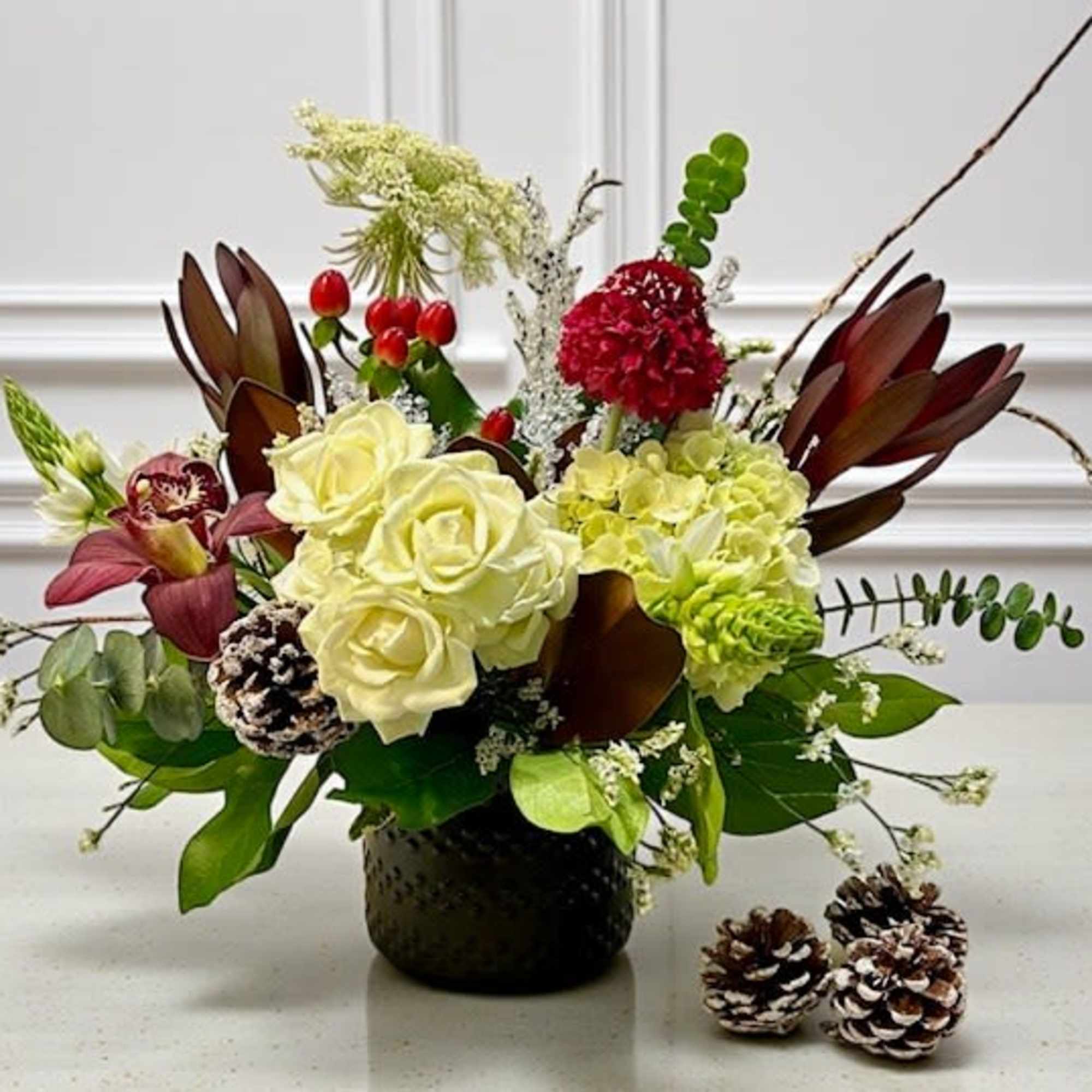 A chic winter design in a sleek black ceramic vase, featuring an