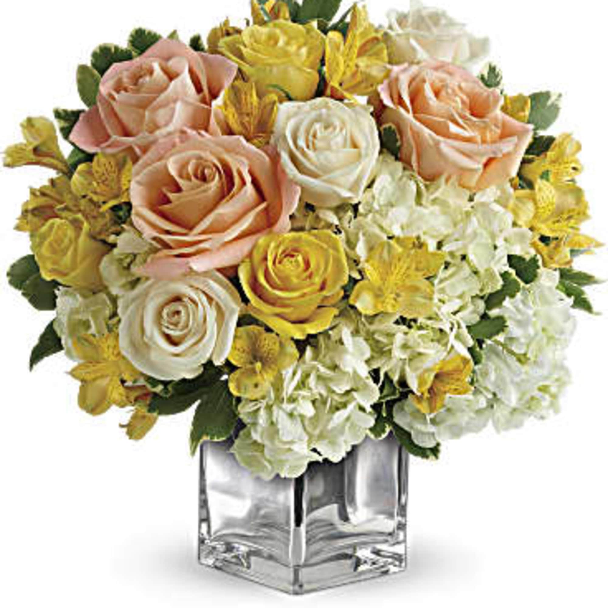 This sparkling array of sunny favorites in a silver cube vase will