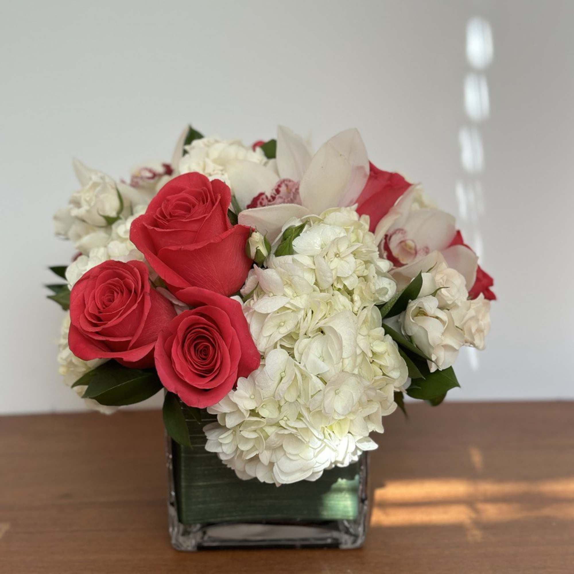 Classic and Beautiful, this arrangement whispers luxury. Pinks, whites and creams come