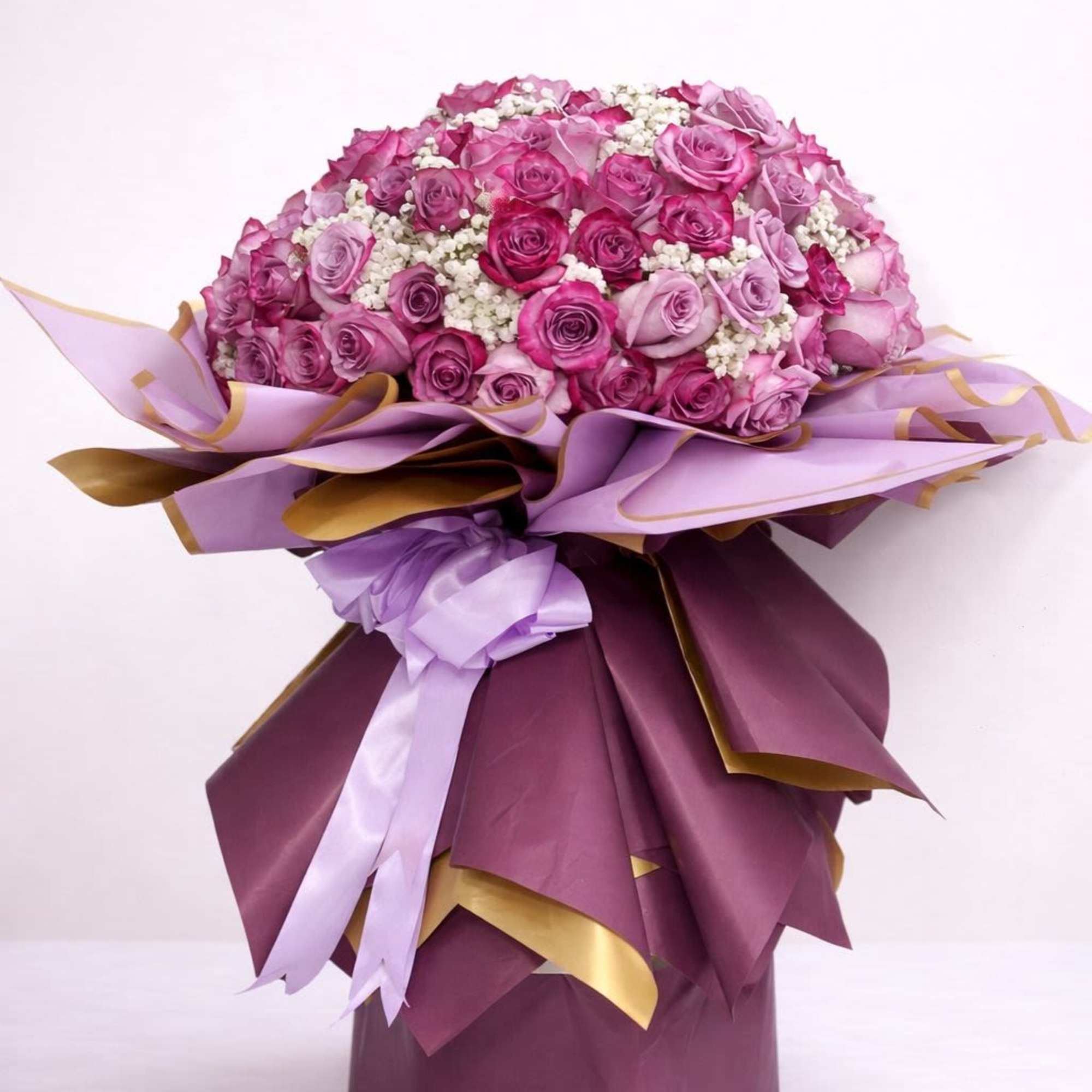 Twenty-Five Lavender and Purple roses in a classic wrap using the same