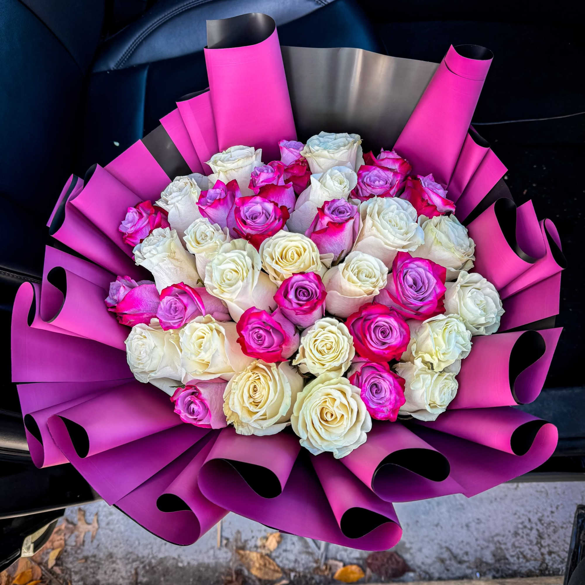 This bouquet is a stunning arrangement of elegant white and vibrant pink
