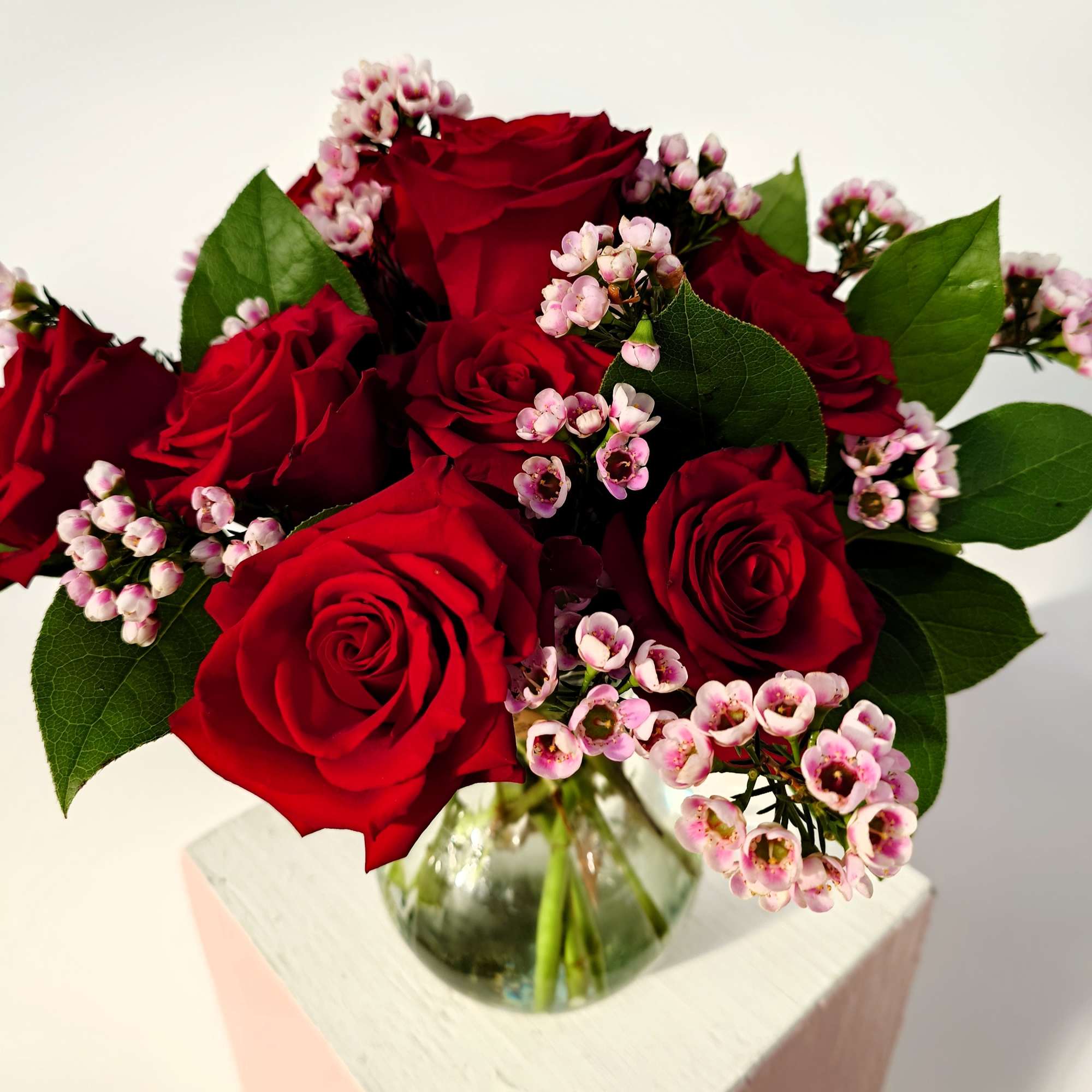 A perfectly petite gesture of love. Six fresh roses are artfully arranged