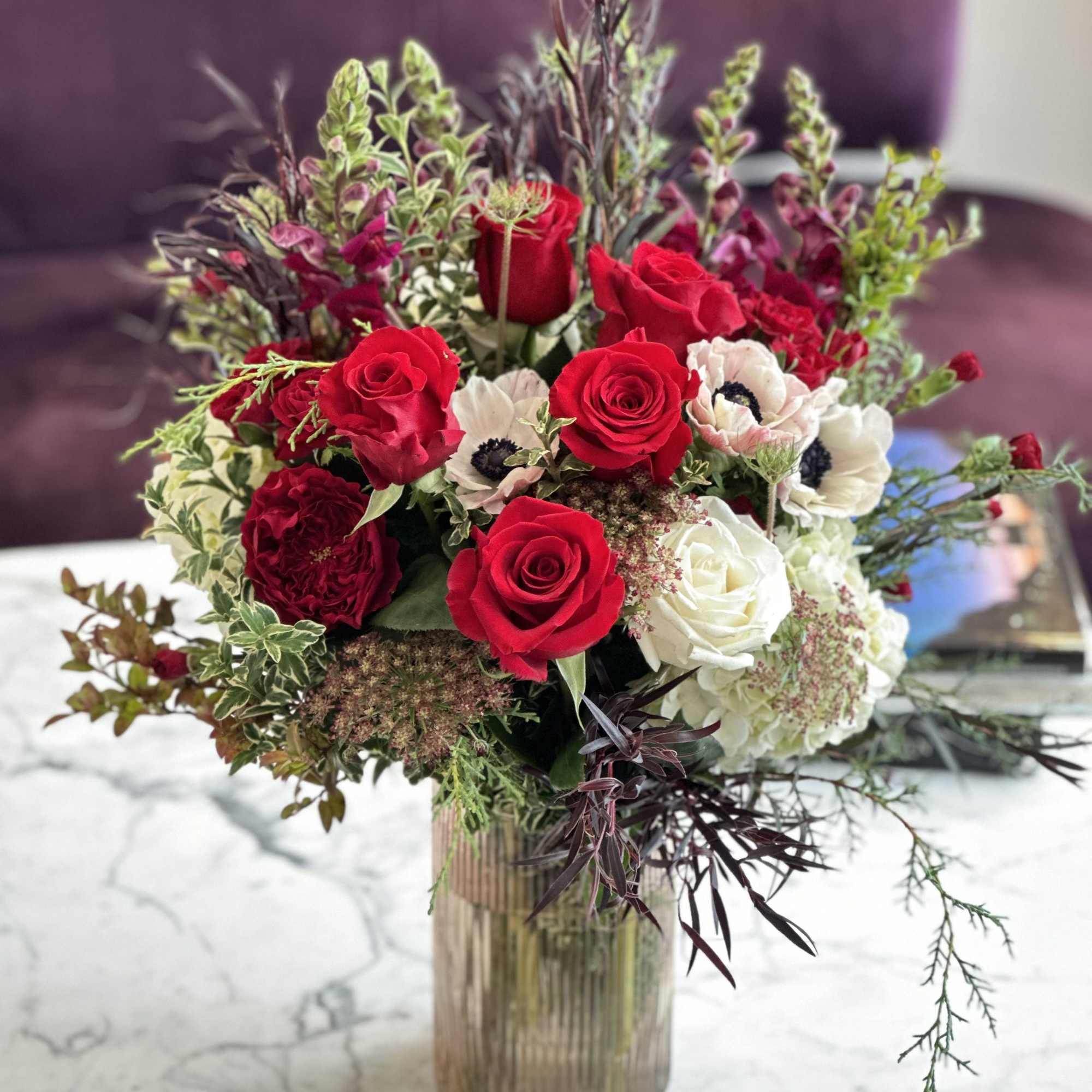 Beautiful lush wintery design of classic red roses and delicated white and