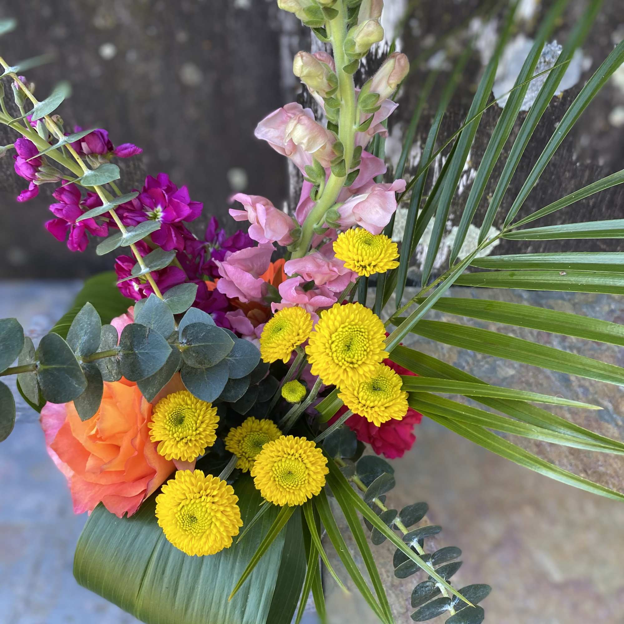 This petite arrangement will brighten up their day! The flower types and