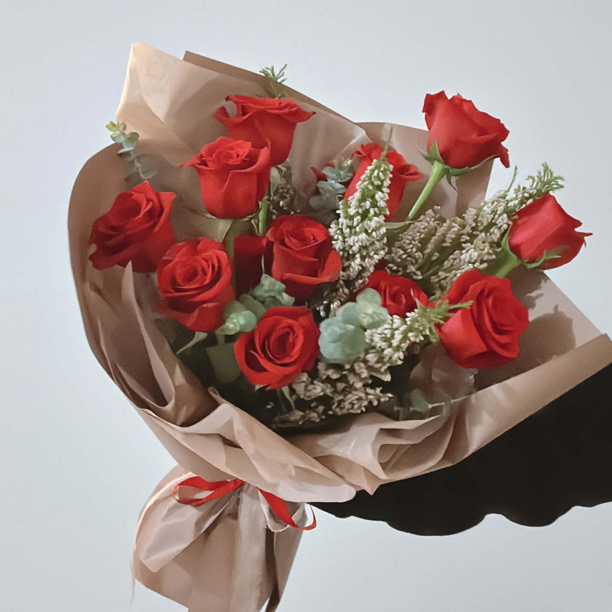 Roses with greens and fillers. 
Standard features 12 roses with others
Deluxe features