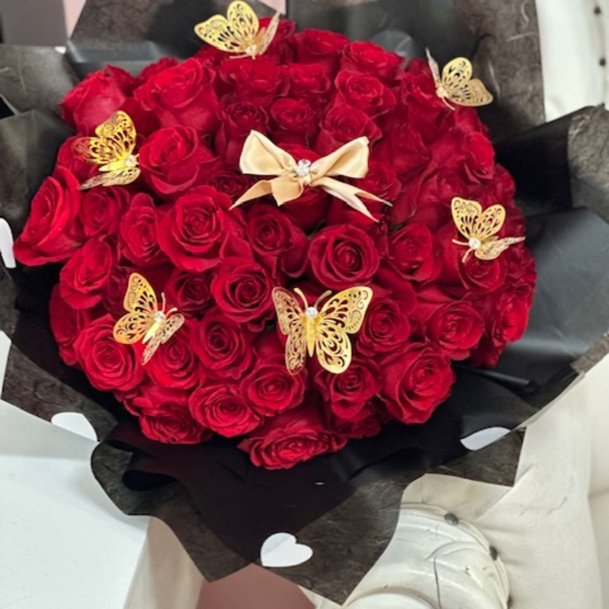 100  red roses with butterflies. amount of roses vary depending price