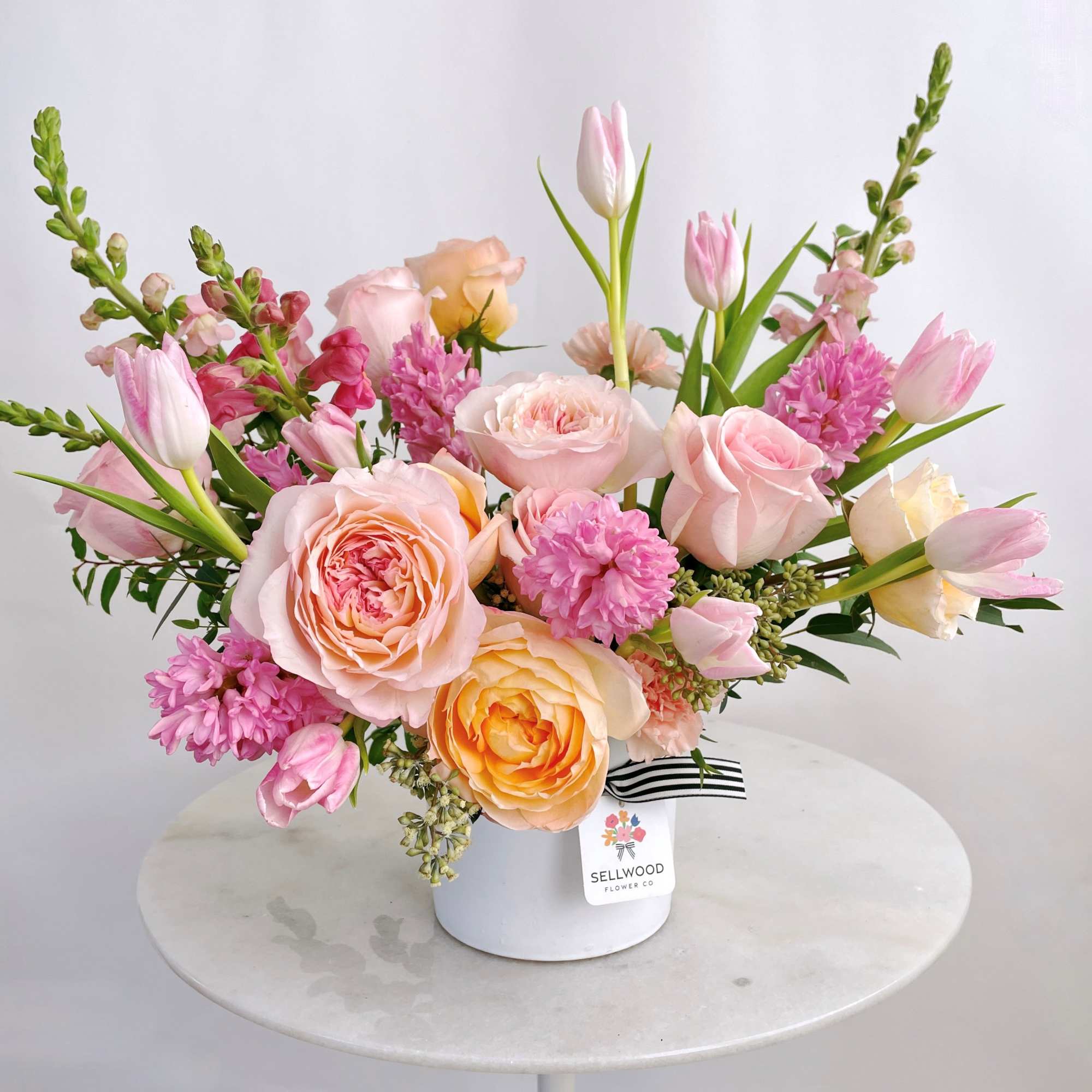 This sweet arrangement is lovingly created with a focus on pinks and