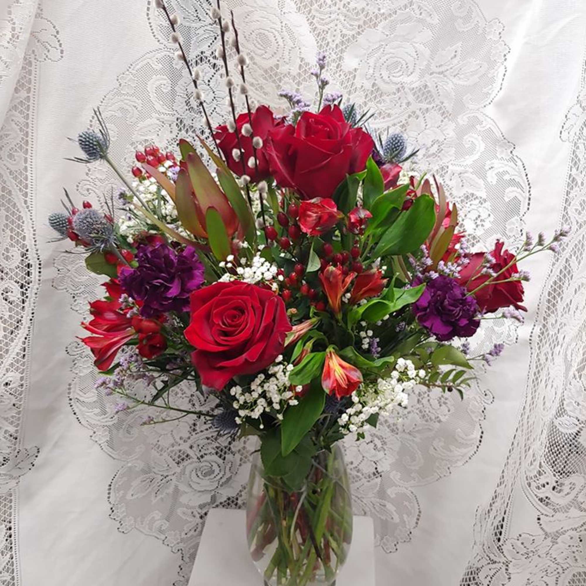 Our premium red Explorer roses, Alstroemaria and purple Moon Vista carnations with