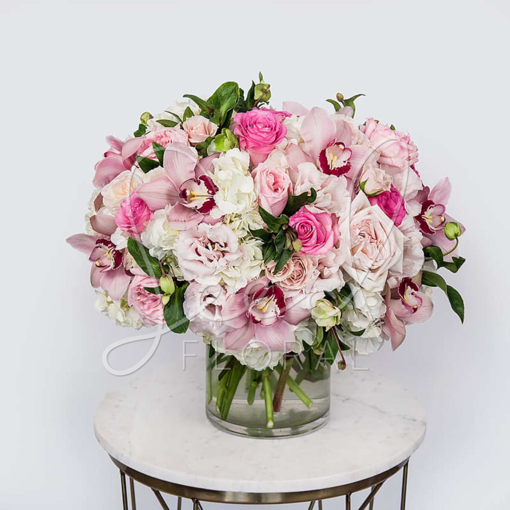 Our Pink Glamour arrangement is a stunning showcase of elegance, featuring lush