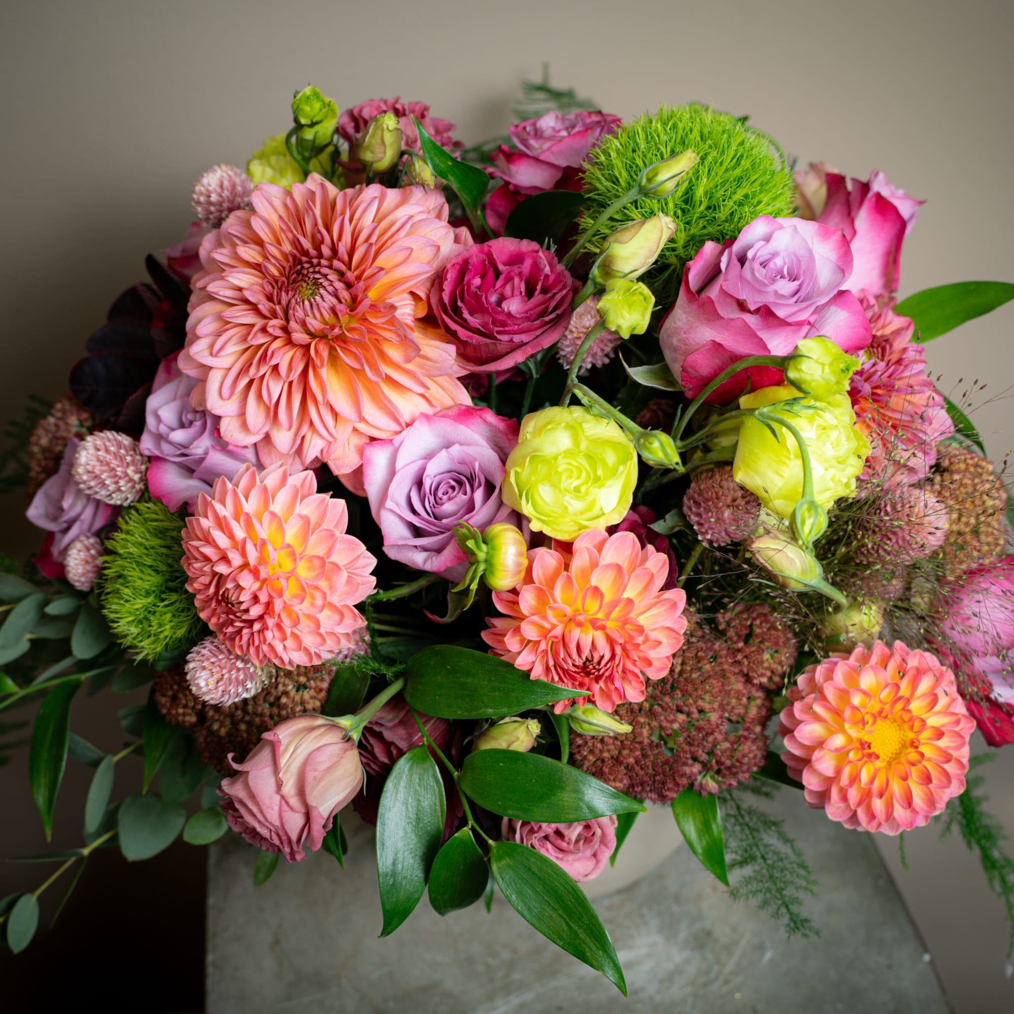 This arrangement of dahlias, roses, clover, dianthus, and more brings together an