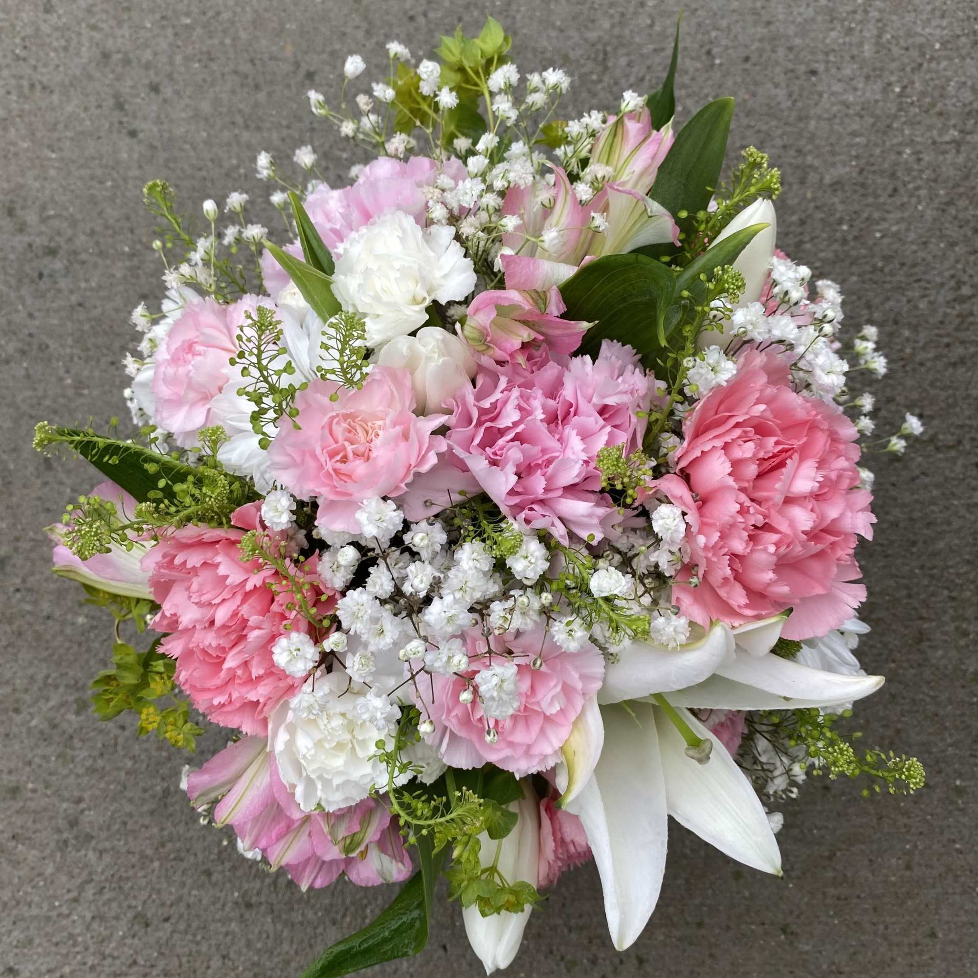 A sweet mix of pink and white Carnations, Lilies and Tulips with