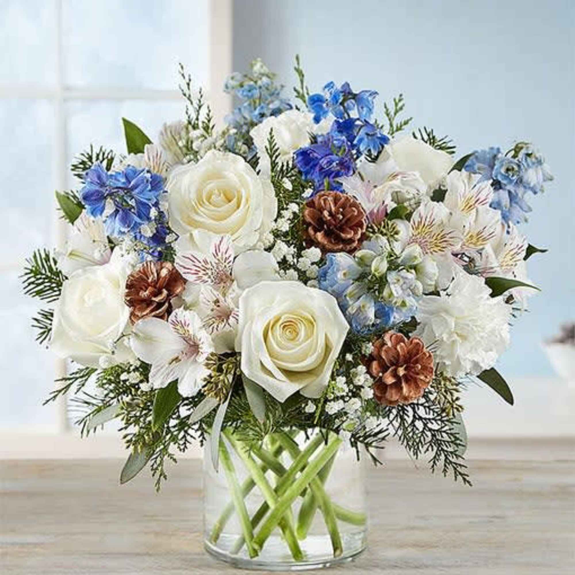 Inspired by winter&rsquo;s cool white &amp; blue landscape, our delightful arrangement delivers