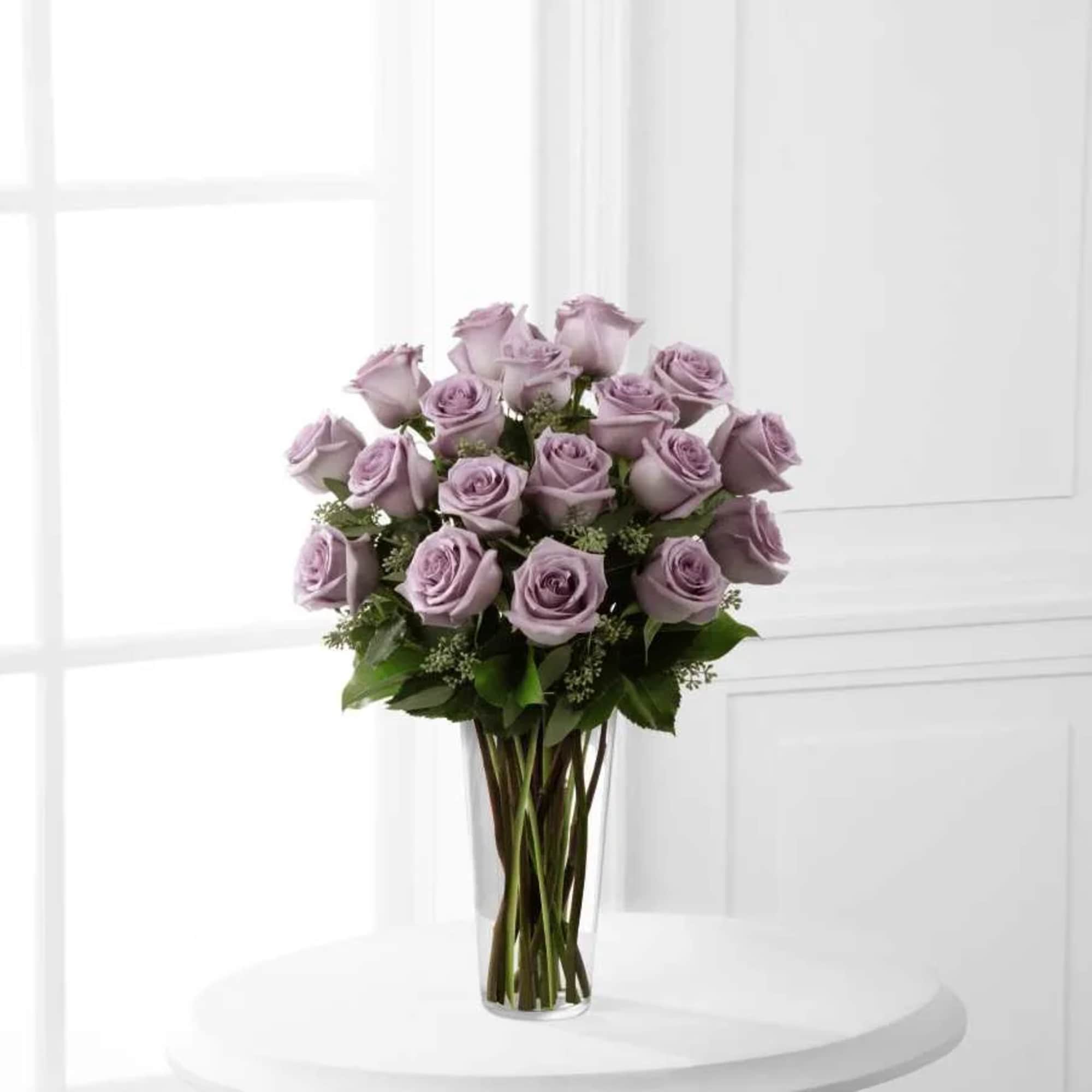 An enchanting bouquet of lavender roses sweetly touches her heart.  The
