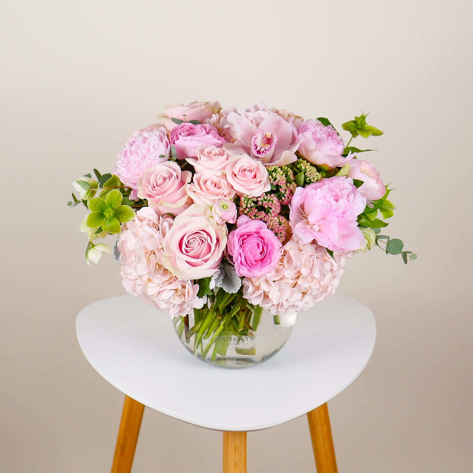 This lush, compact arrangement features a gorgeous collection of pink roses, hydrangeas