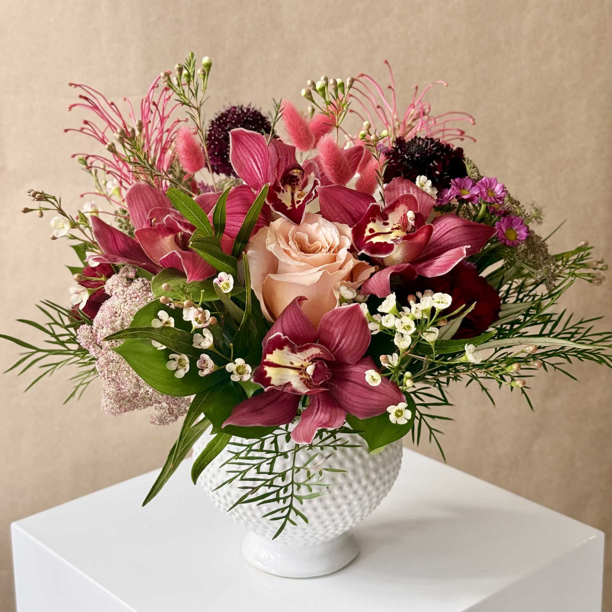 Sweet, romantic assortment of flowers arranged in a short design within a