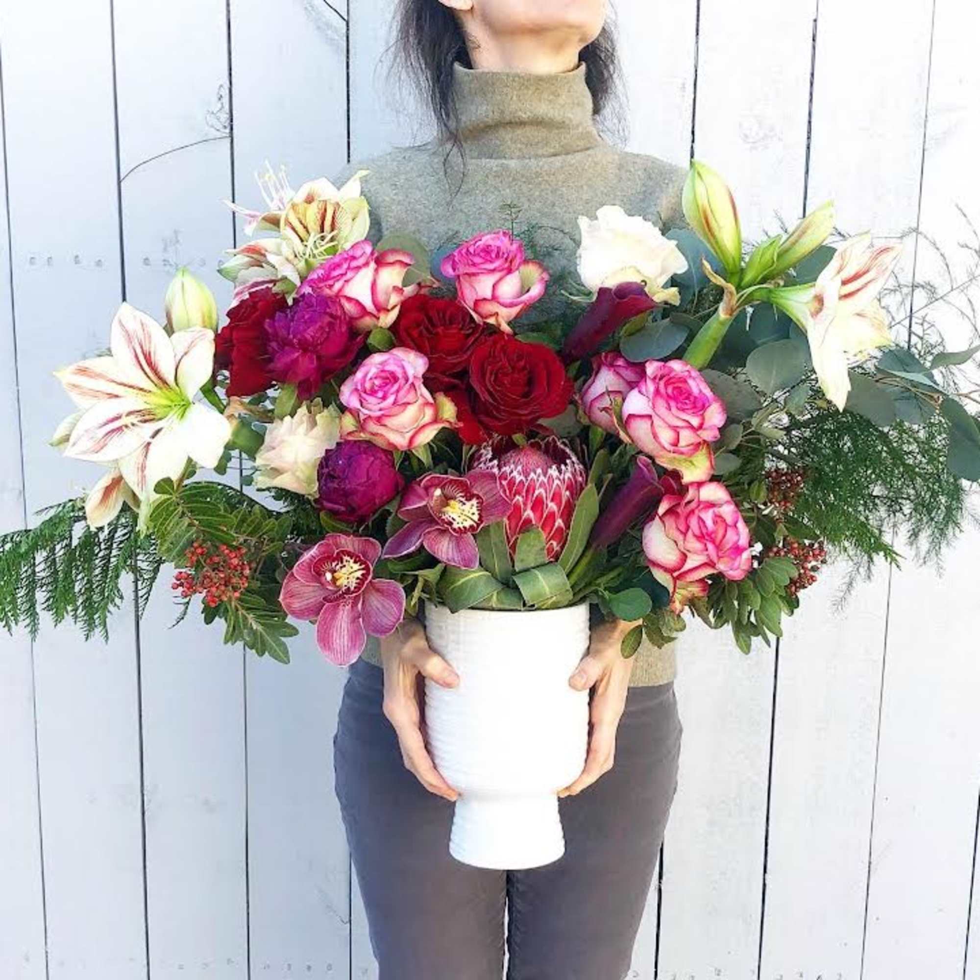 Love is in the air with lush orchids and bold king proteas.