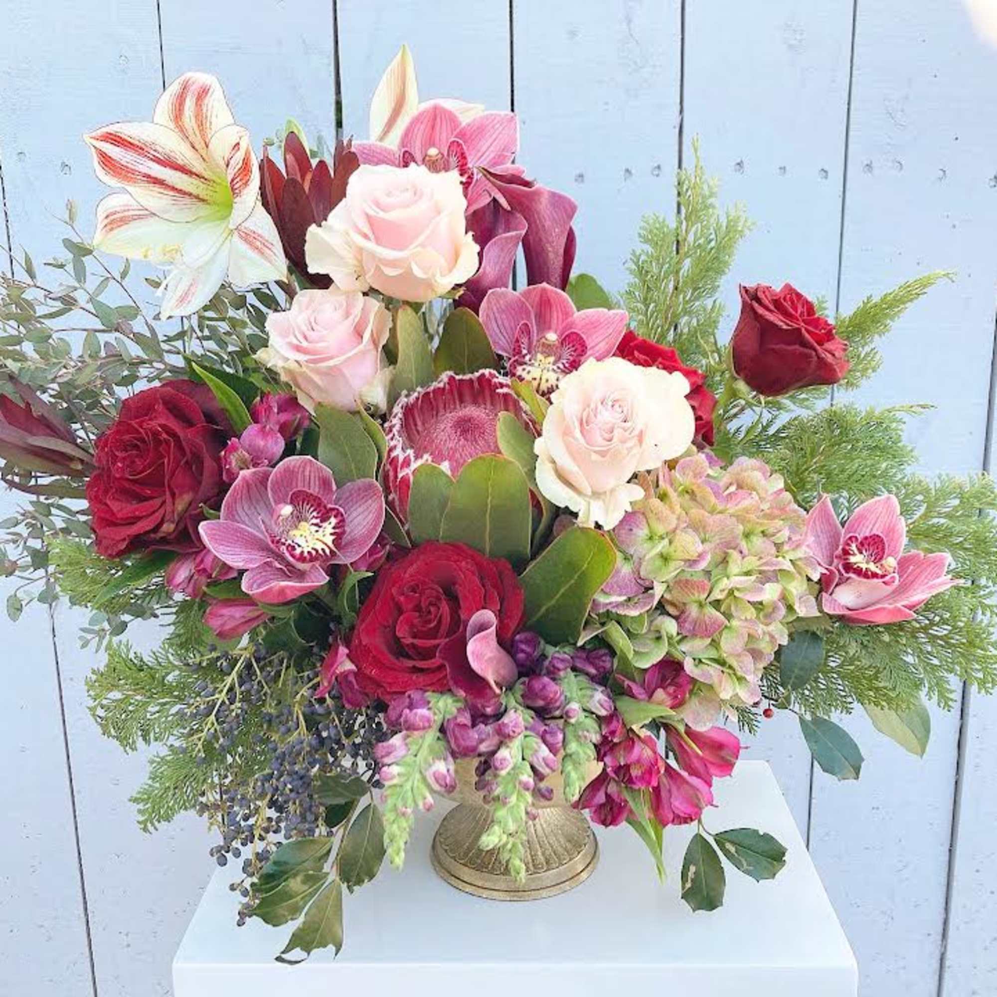 A beautiful collection of unique blooms with pink ice protea, candy-cane peppermint