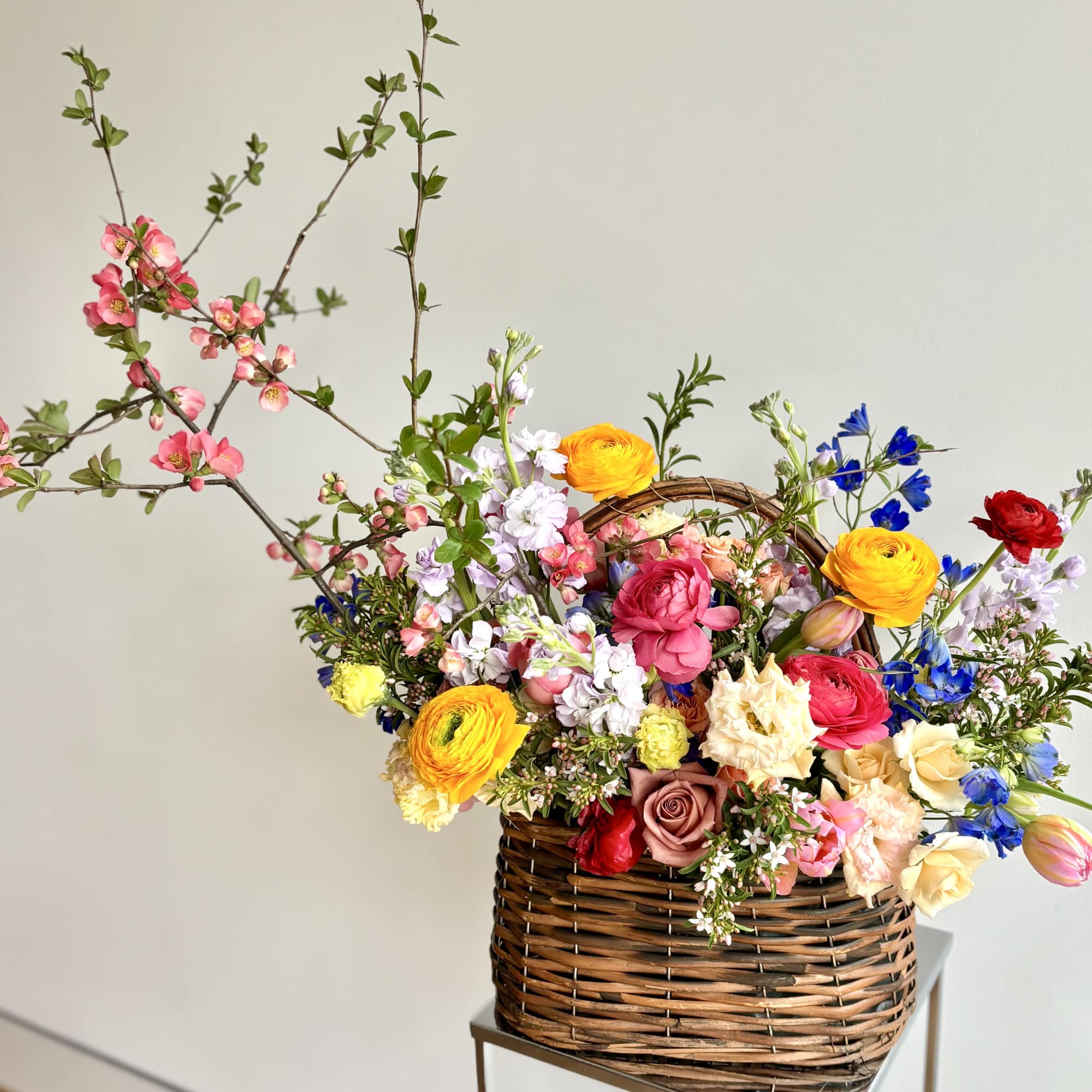 Woven basket filled with premium flowers to celebrate this season - a
