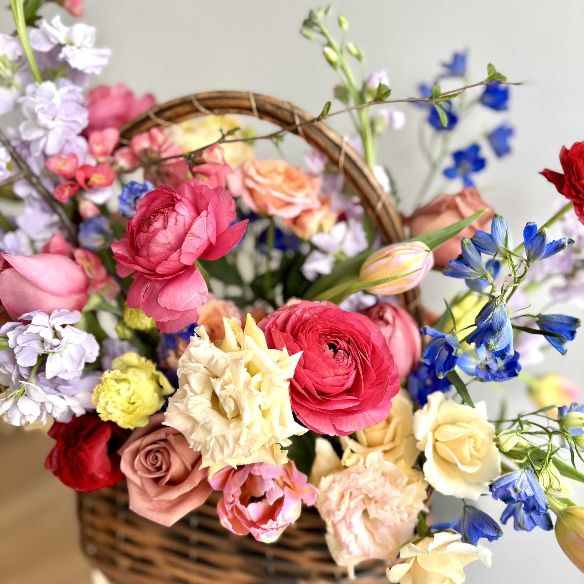 Woven basket filled with premium flowers to celebrate this season - a