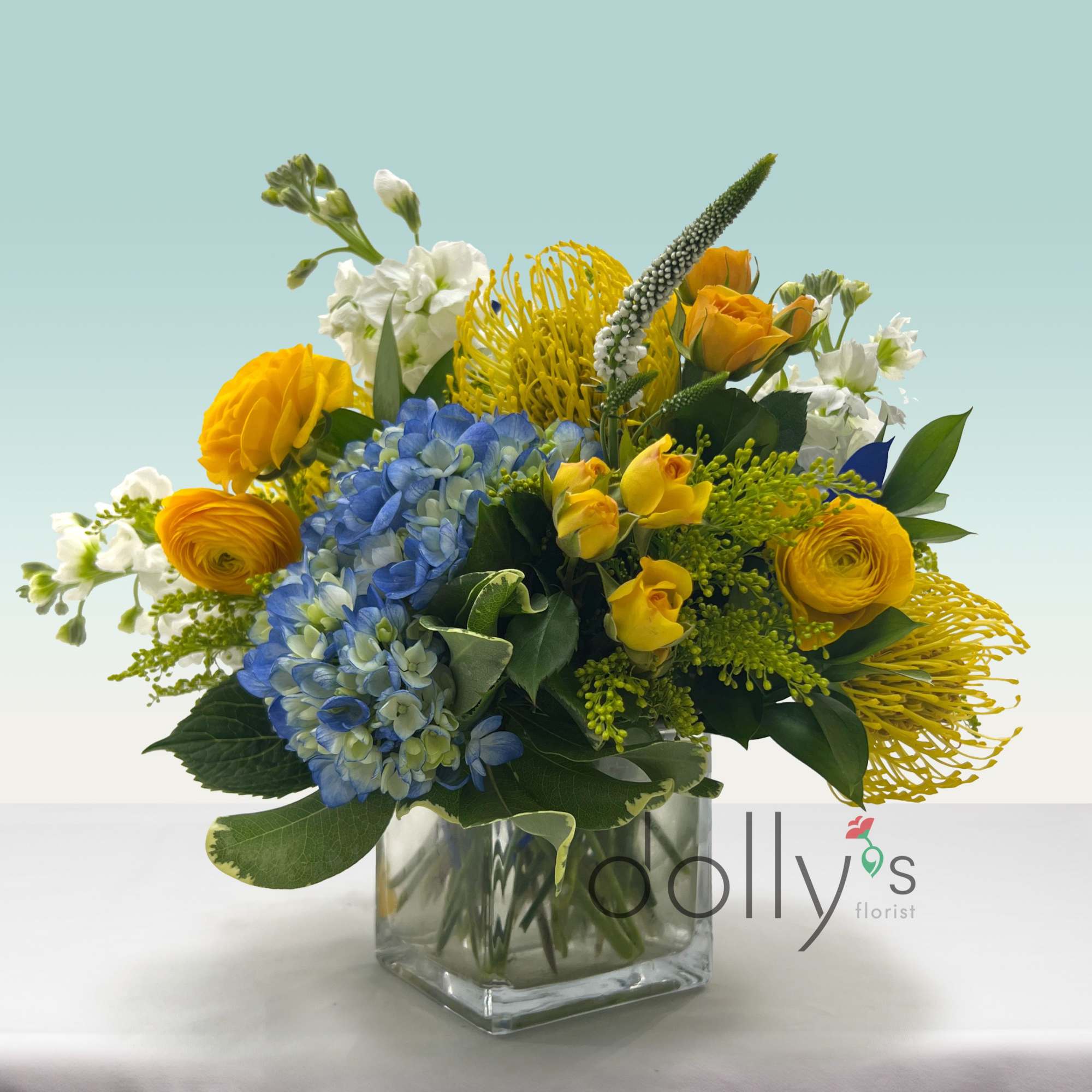 Bring in some cheer with this combinations of yellow protea, spray roses