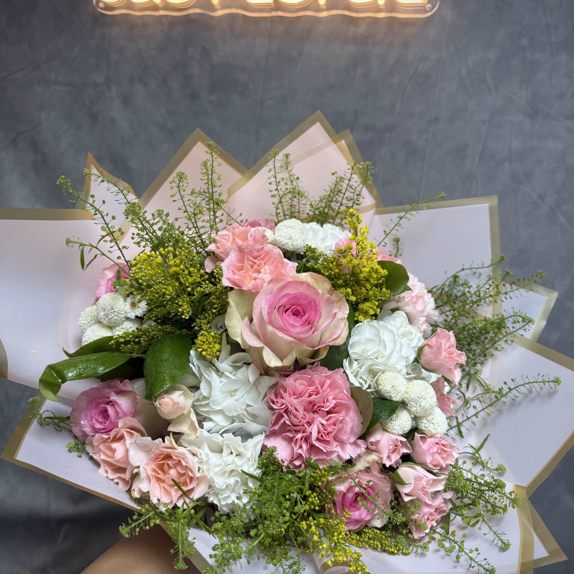 A beautiful bouquet of pink roses &amp; carnations with white hydrangeas 