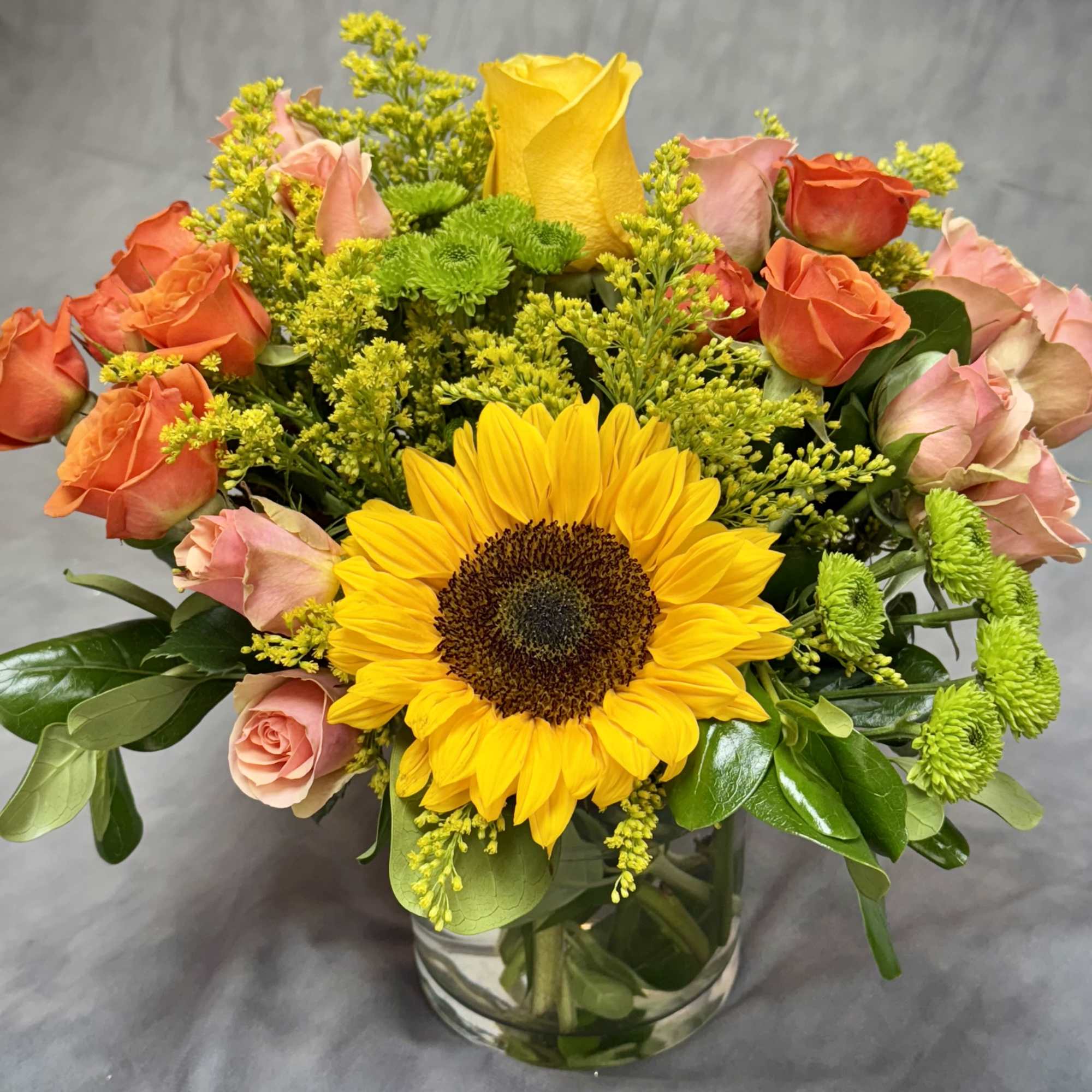 Sunset Symphony is a vibrant medley of golden sunflowers,  pink and