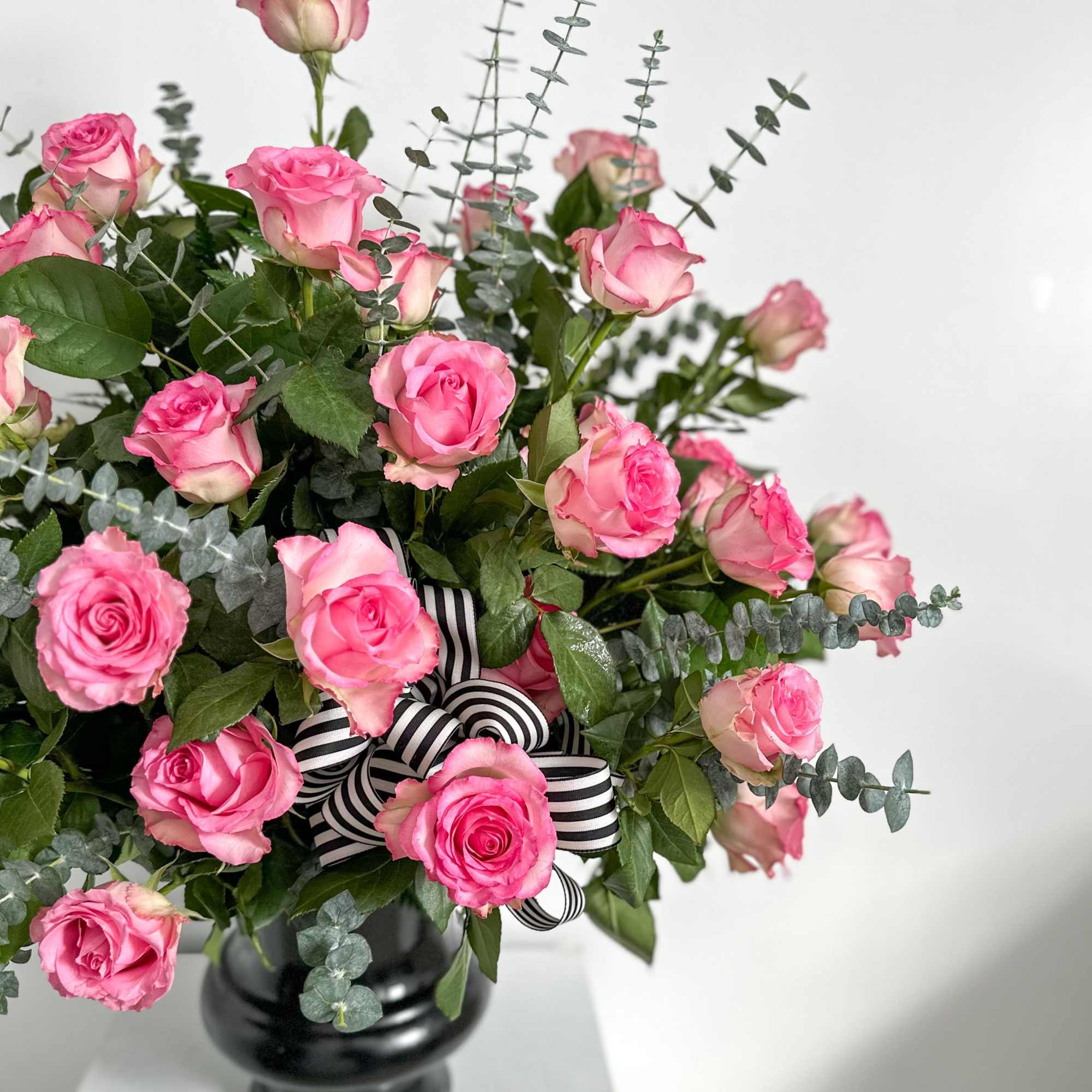 This all rose urn contains 3 dozen roses of your choice, and
