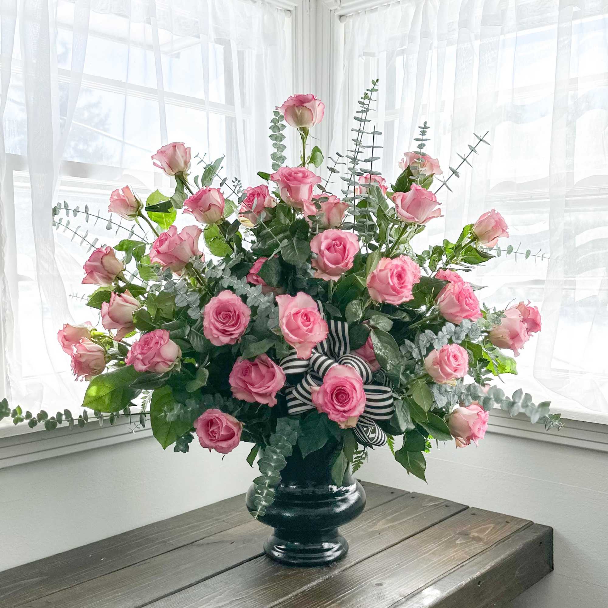 This all rose urn contains 3 dozen roses of your choice, and