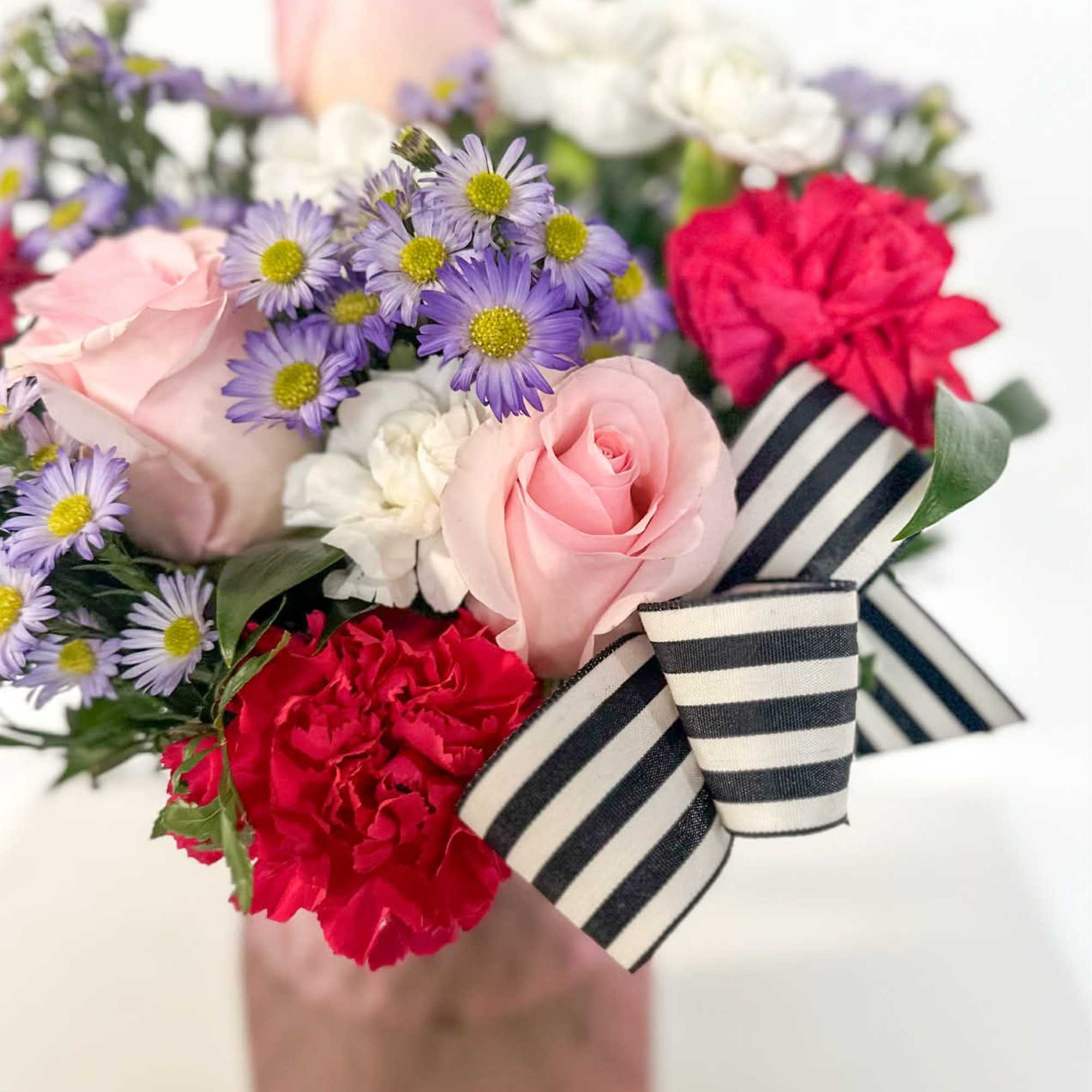 Blushing Harmony is a cheerful and elegant arrangement featuring soft pink roses