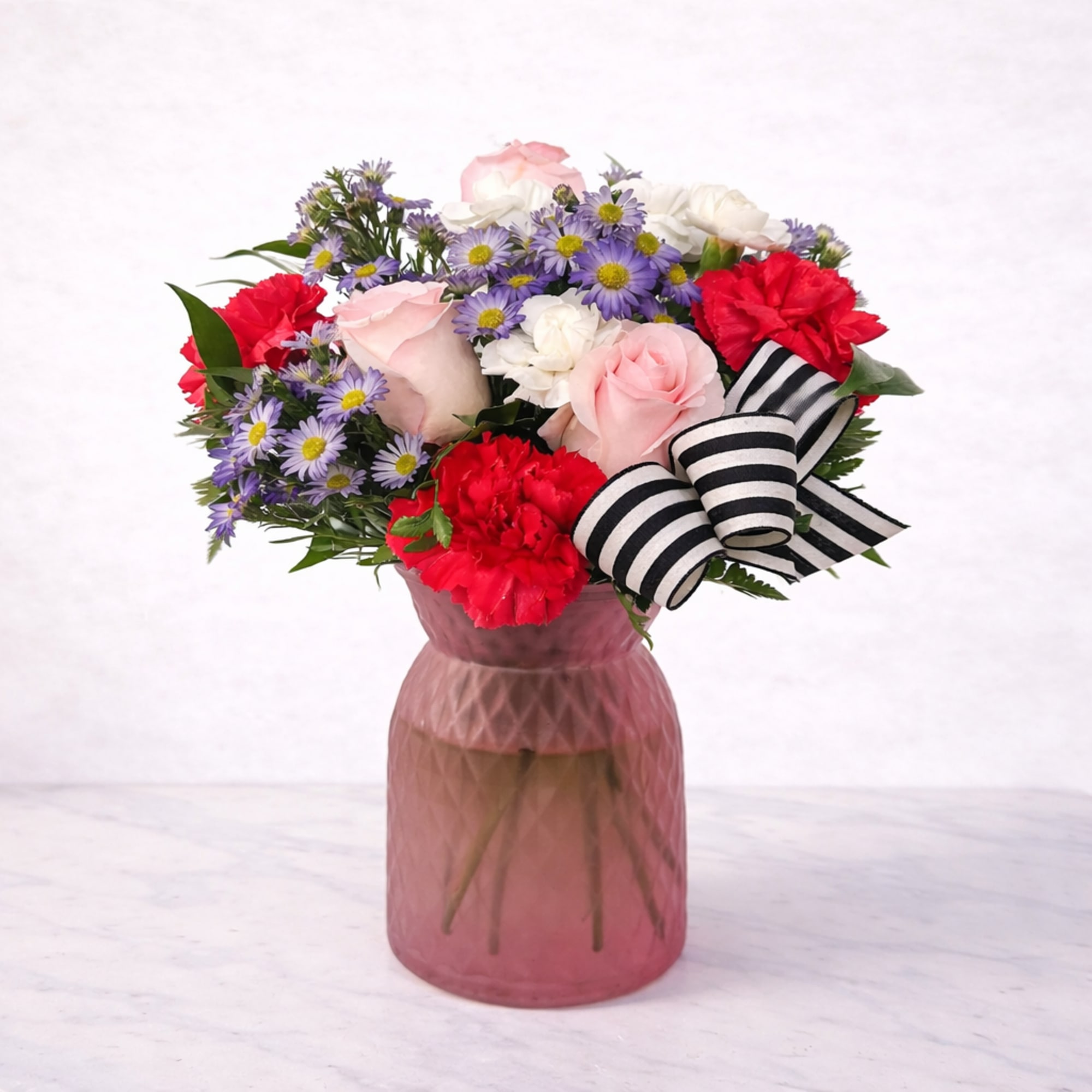 Blushing Harmony is a cheerful and elegant arrangement featuring soft pink roses