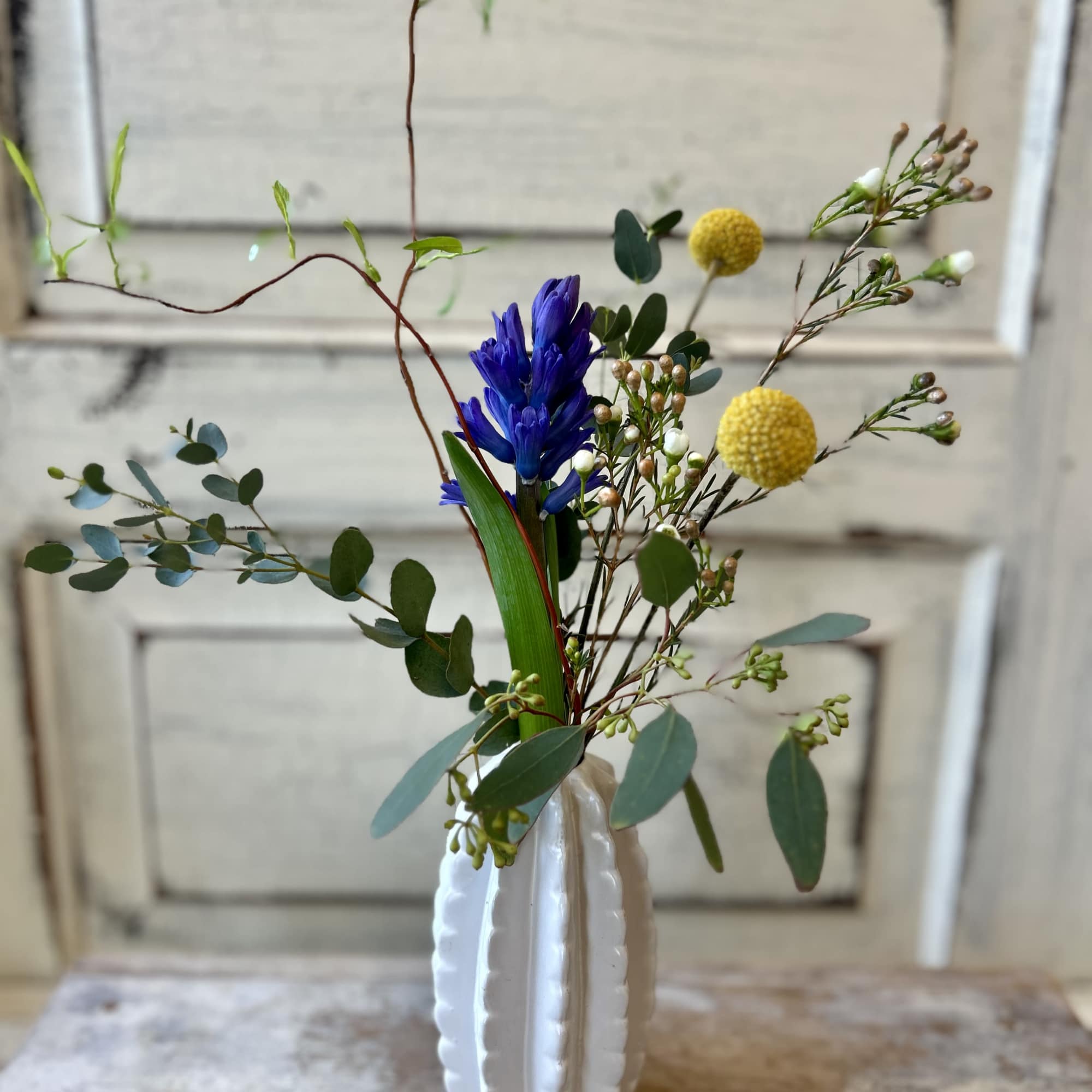 A unique ceramic vase holds the just right combination of blooms and