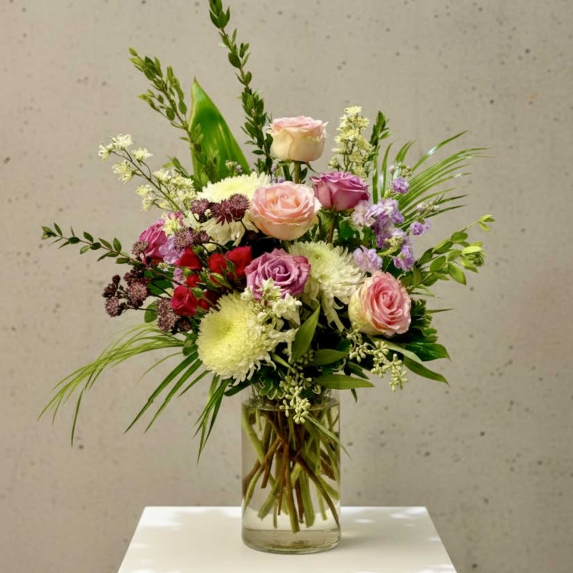 A stunning floral arrangement in a tall vase, offering a serene and