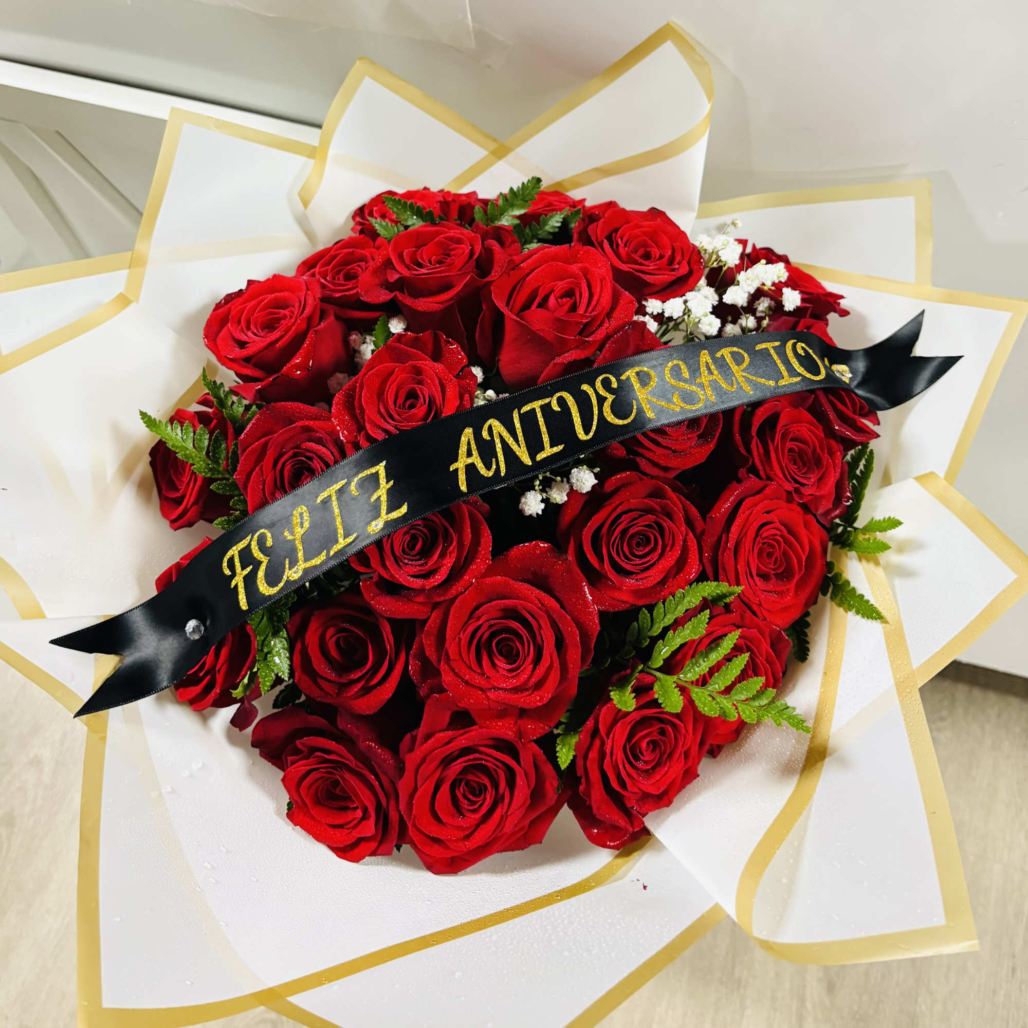 this is our Classic Ramo Buchon, containing classical Red Roses with Baby's