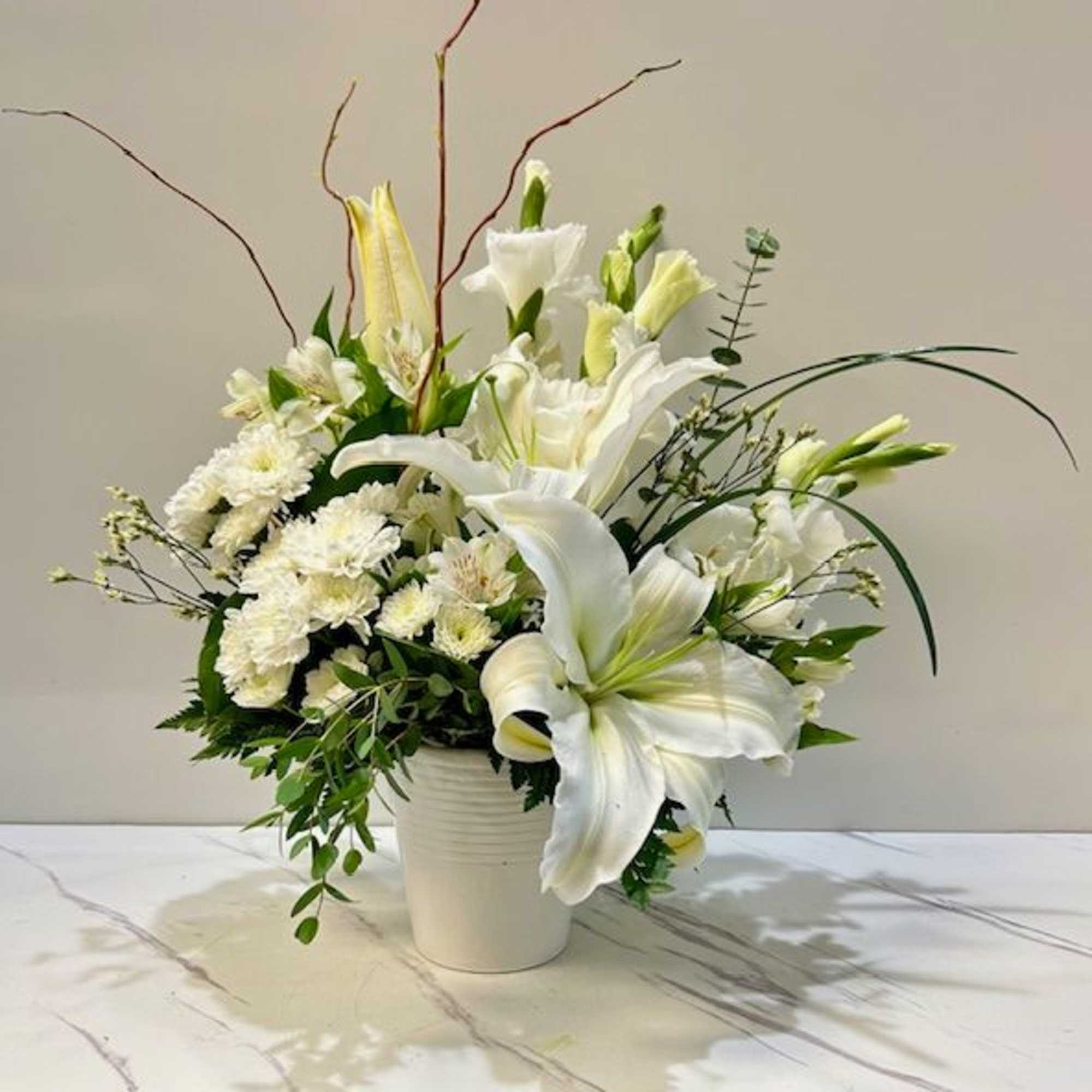 Elegant and serene, Pure Radiance is an all-white floral arrangement that symbolizes