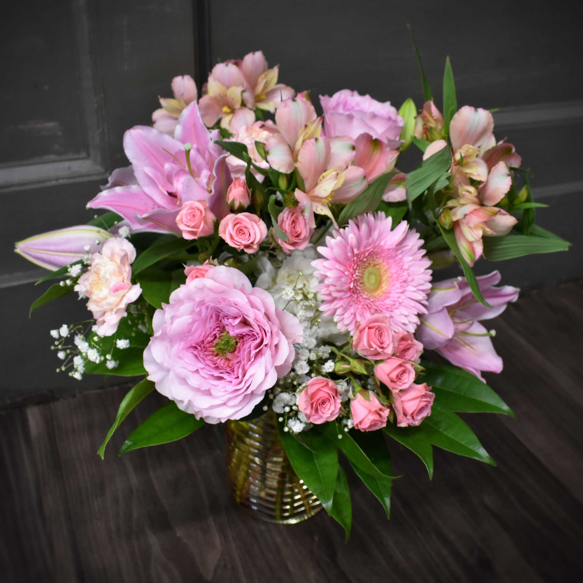 This stunning arrangement blends the timeless beauty of garden roses, the charm