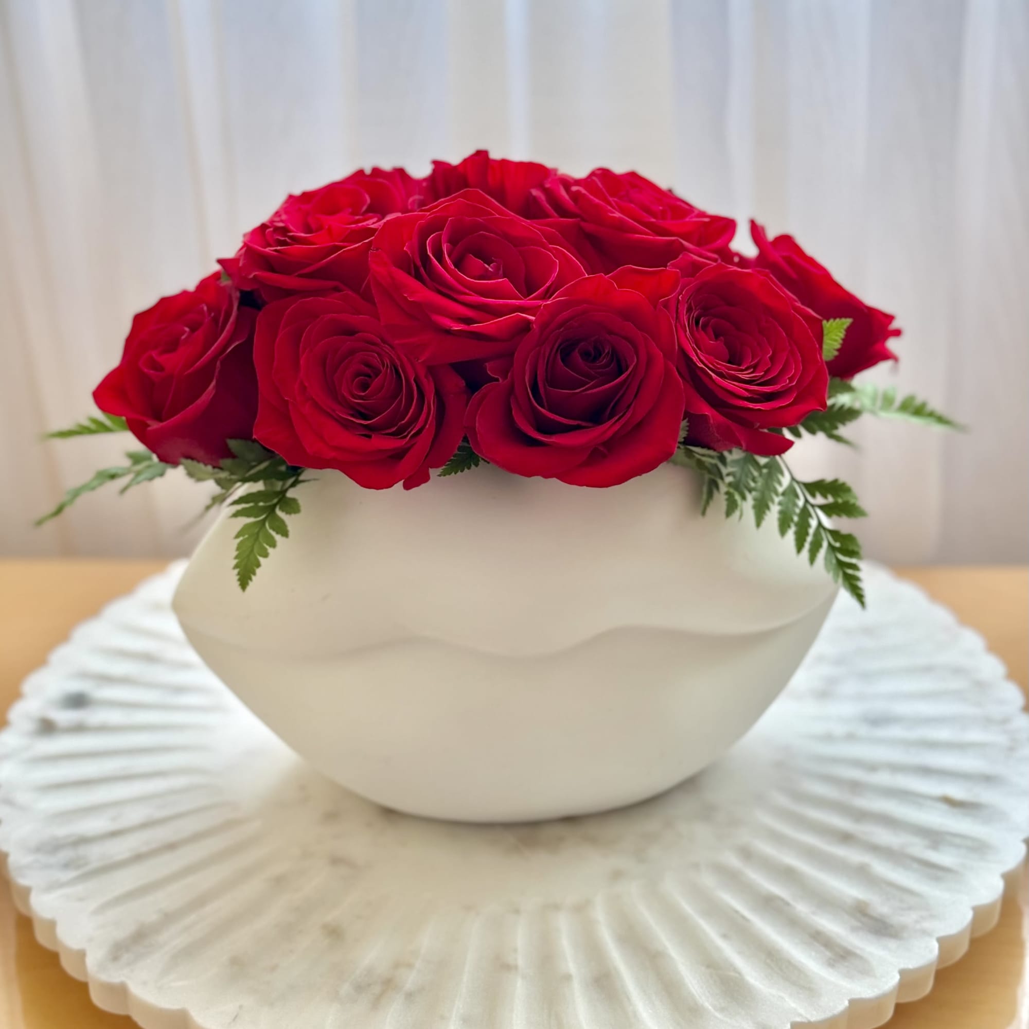 A floral arrangement designed to capture hearts. This piece features a lush