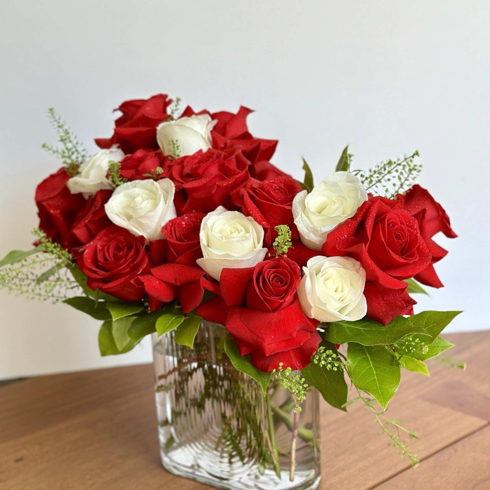Surprise her with not one but fourteen gorgeous red roses and eight