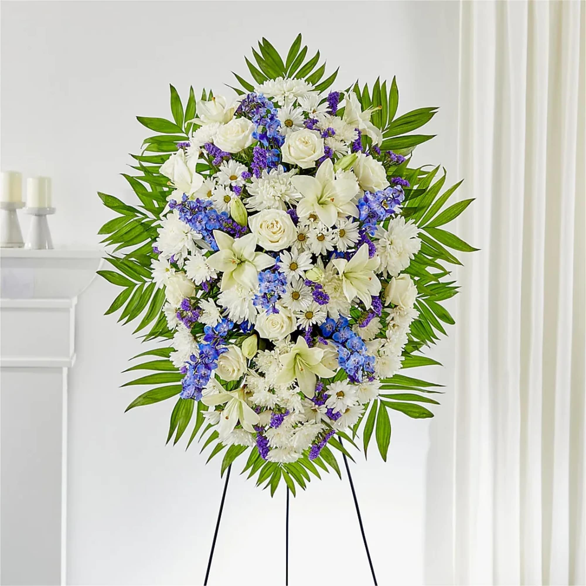 Pay your respects with a standing tribute of white and blue florals