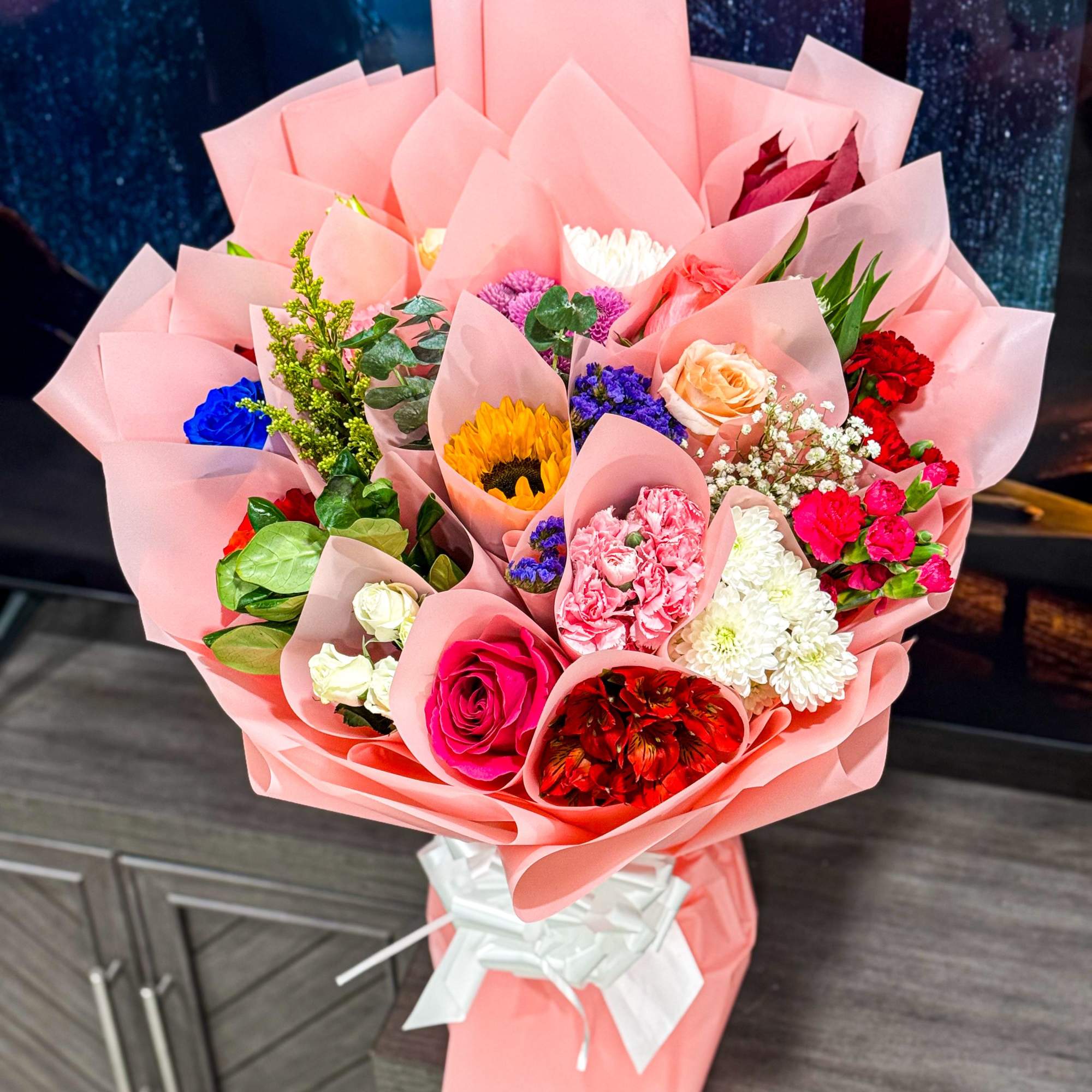 is a stunning hand-crafted bouquet wrapped in our signature Korean-style blush wrap.
